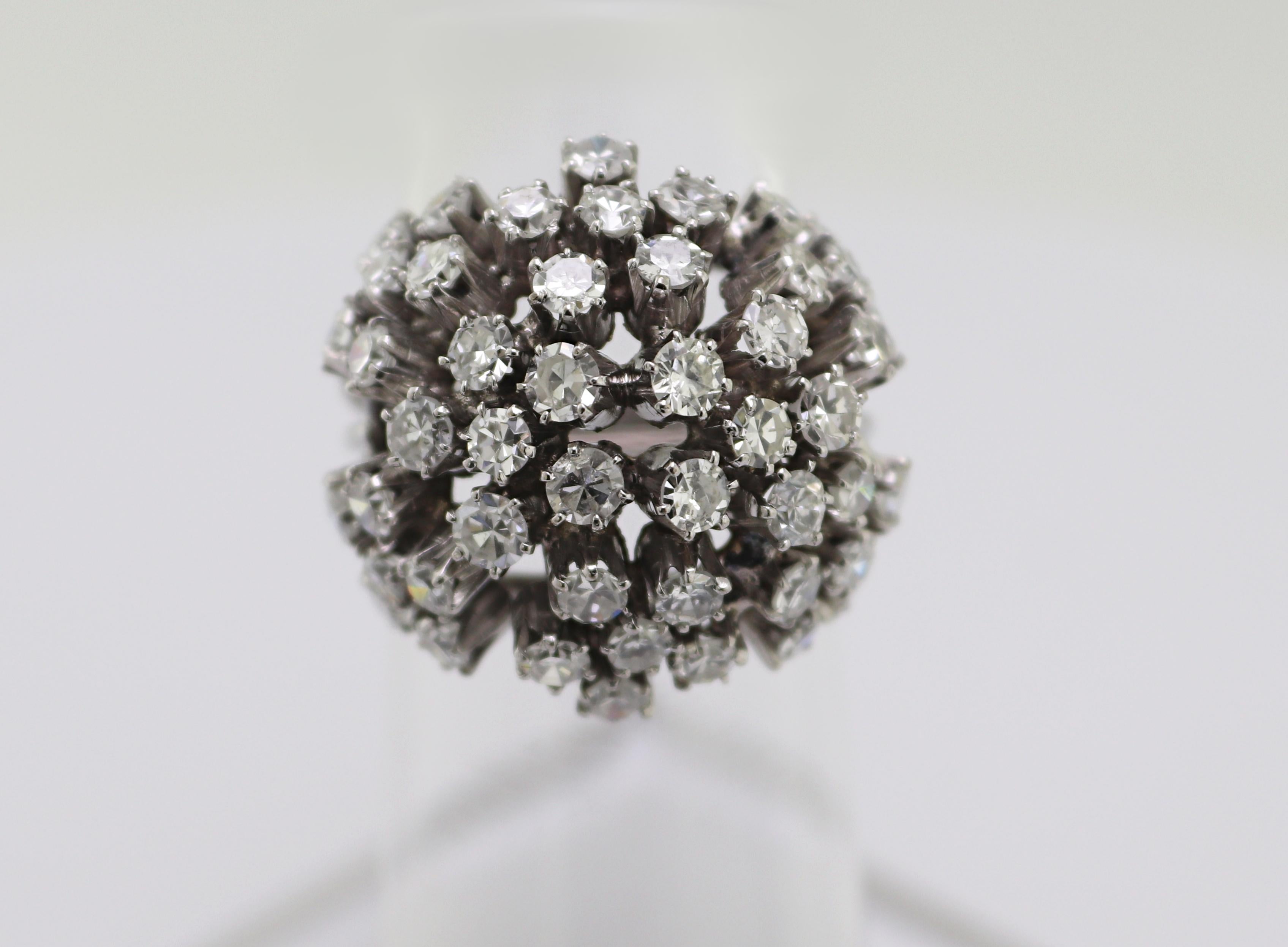 Featuring numerous single-cut diamonds, 2.75 ct., tw., SI-I, H-I, set in an
18k white gold bombe form flower motif mounting, 19 X 19 mm to 2.9 mm,
size 4, Gross Weight 6.80 grams.