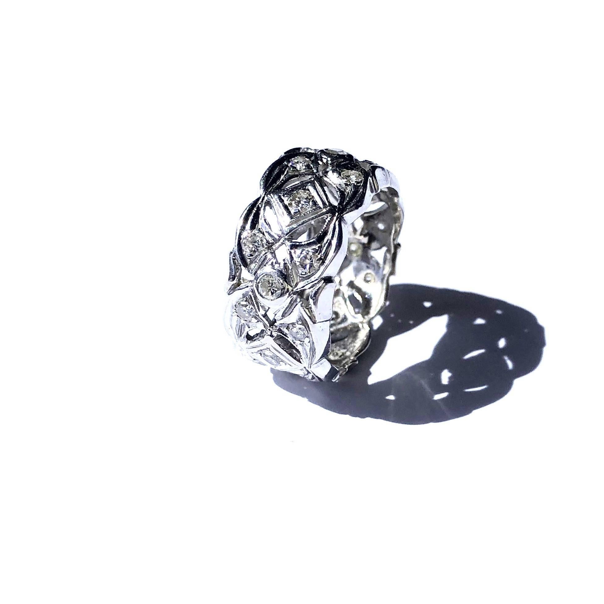 Crafted in 14K white gold, the band features an open work diamond set design. 
24 round brilliant cut diamonds: approximate total weight of 0.80ct. Color: G-H, Clarity: VS2-SI2
Measurements:
Width: 10.5 mm
Weight: 5.7 grams
Size: 7