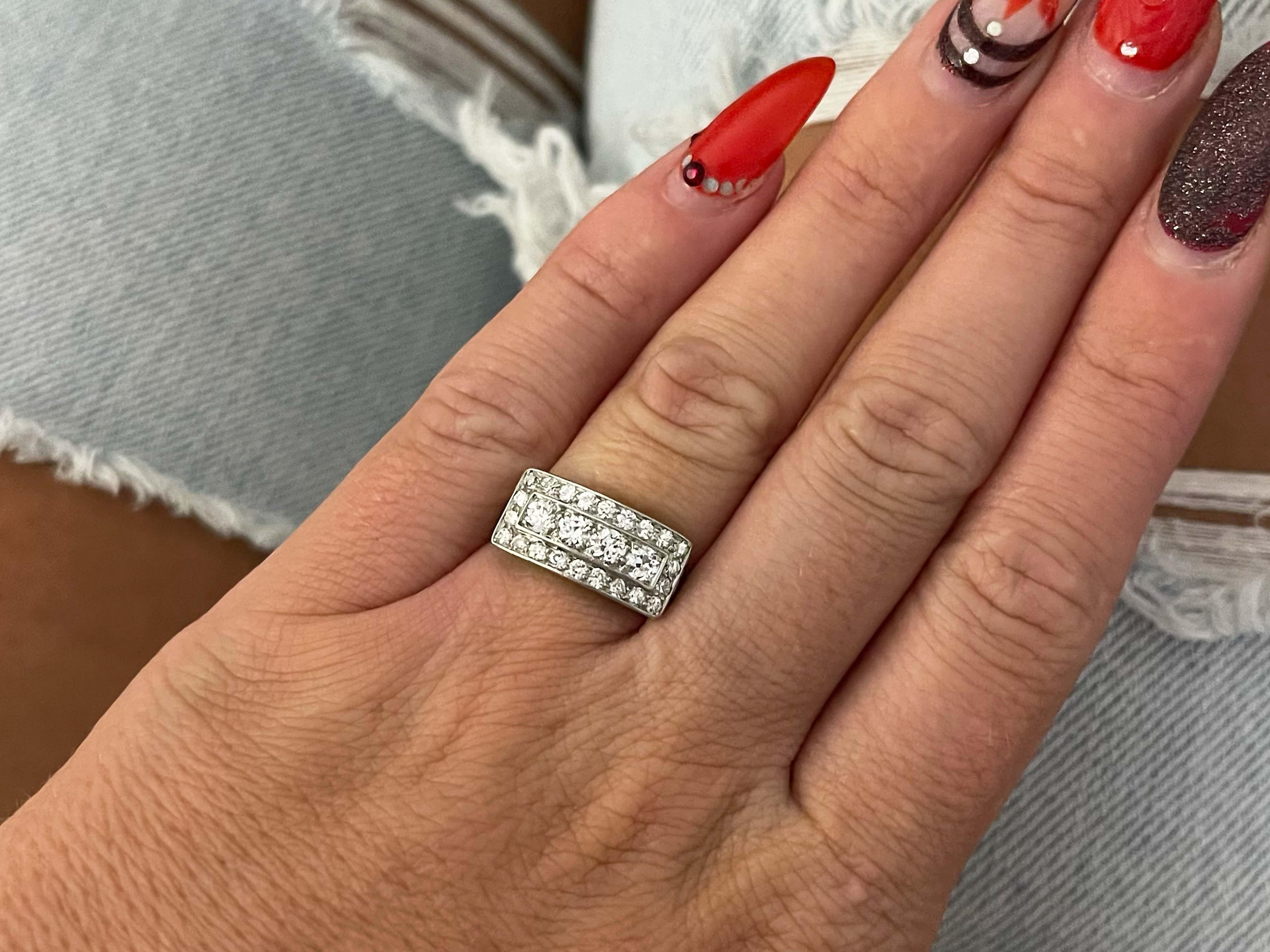 Ring Specifications:

Gender: Women 

Style: Wide Diamond Band Ring

Metal: Platinum 

Ring Size: 5.75 (ask about resizing)

Total Ring Weight: 4.4  Grams
​
​Ring Height: 8.59 mm

Total Diamond Weight: ~0.60 carats (4 center) + ~0.44 carats (22
