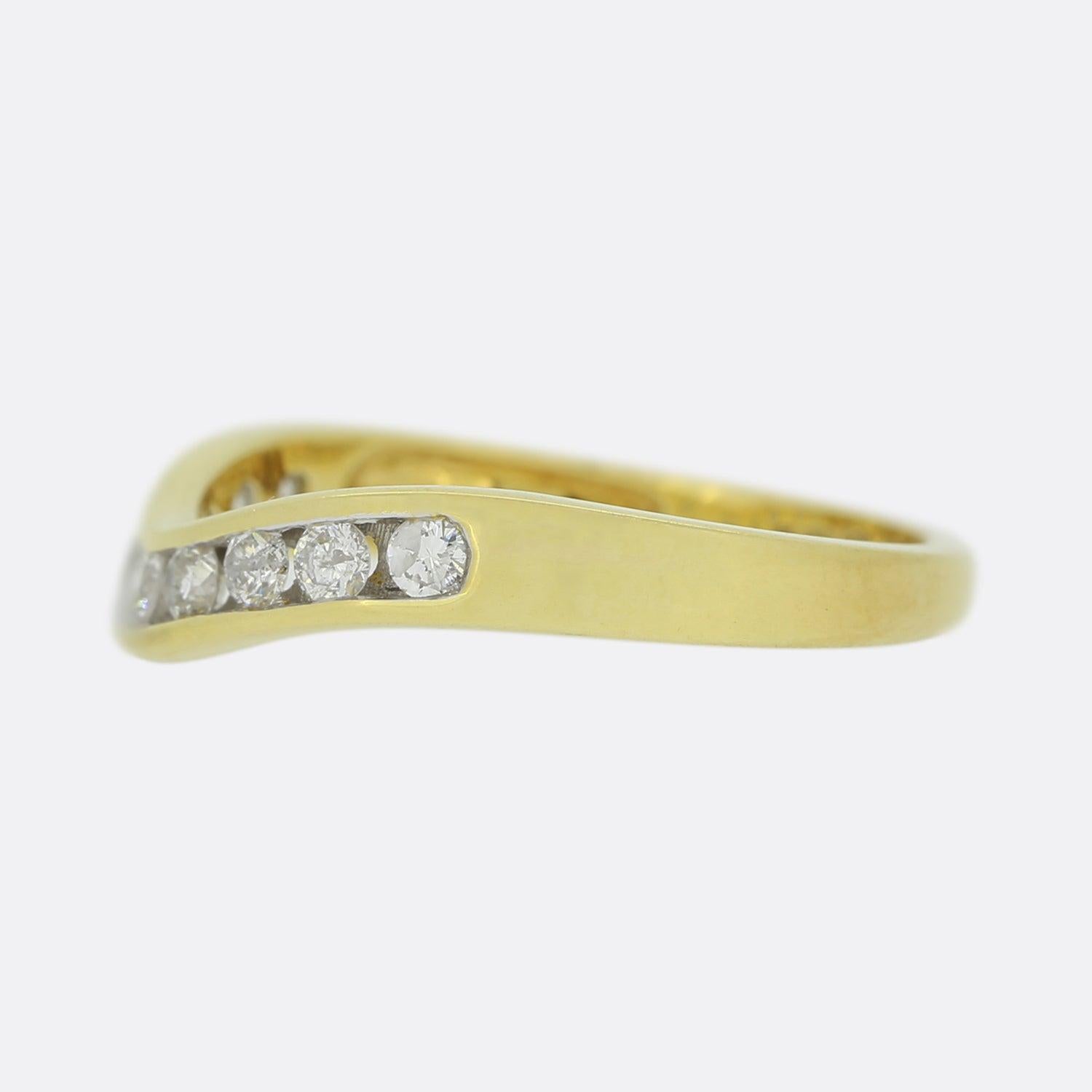 Here we have a classic diamond wishbone ring. Crafted from 18ct yellow gold, this vintage piece presents nine round brilliant cut diamonds; all of which have been closely rub-over set in a single line formation across a V shaped face. 

Condition: