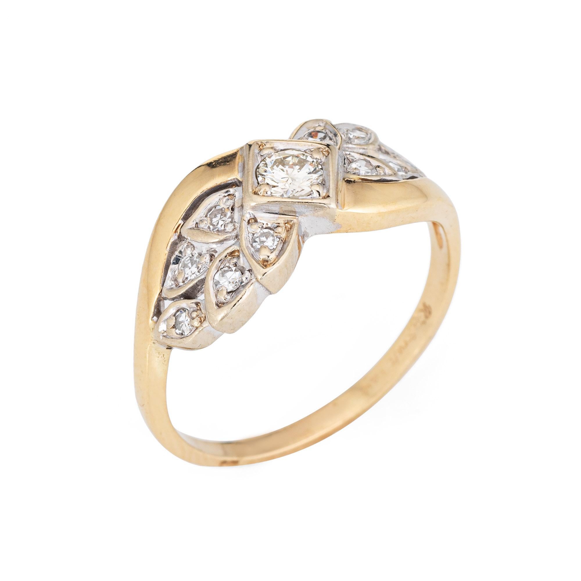 Finely detailed vintage diamond wreath ring (circa 1940s to 1950s) crafted in 14k yellow & white gold. 

Centrally mounted round brilliant cut diamond is estimated at 0.10 carats, accented with 10 estimated 0.01 carat single cut diamonds. The total