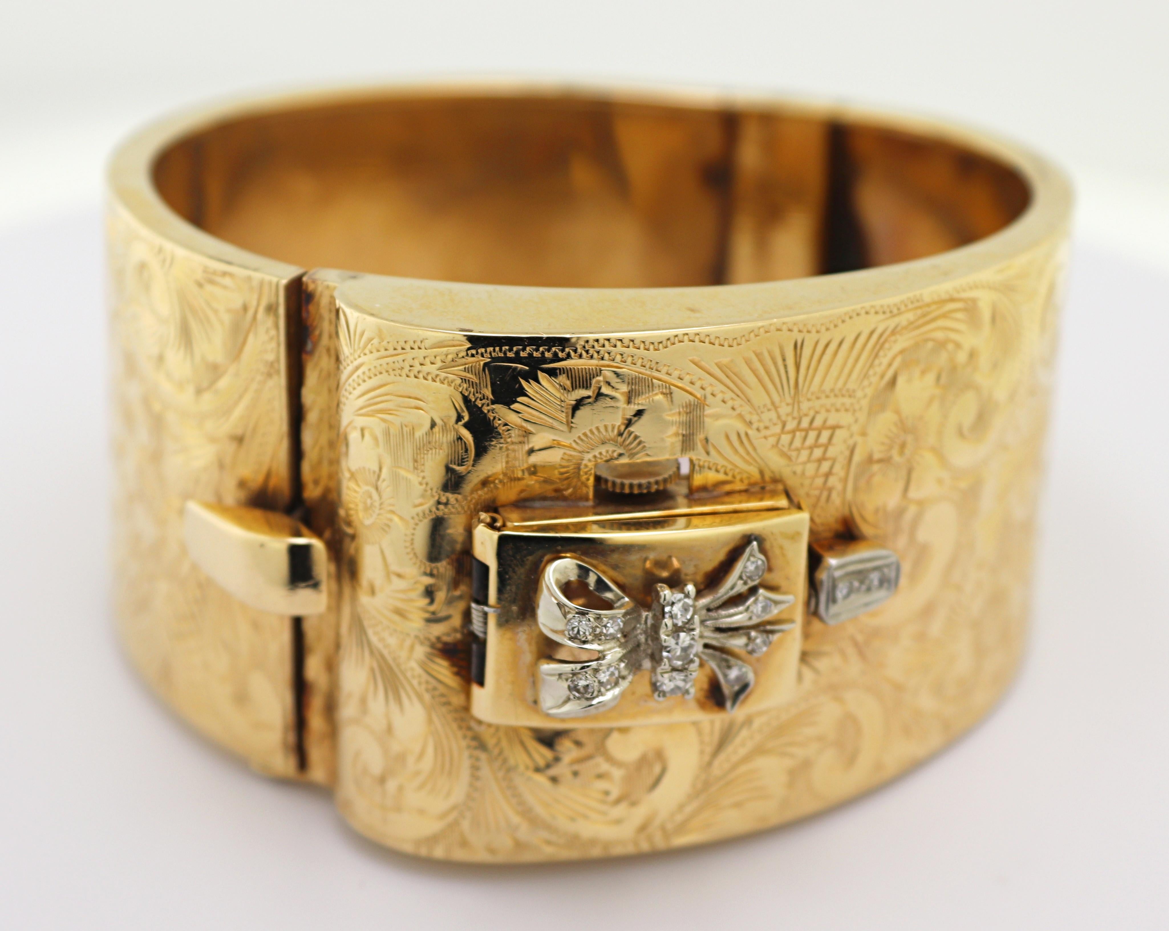 The 14k yellow gold tapering buckle style hinged bangle 27 mm to 30 mm, hand engraved
throughout with floral motifs, featuring a covered watch, with a silvered rectangular dial
(discolored), black Arabic numerals and applied dot hour markers, gold