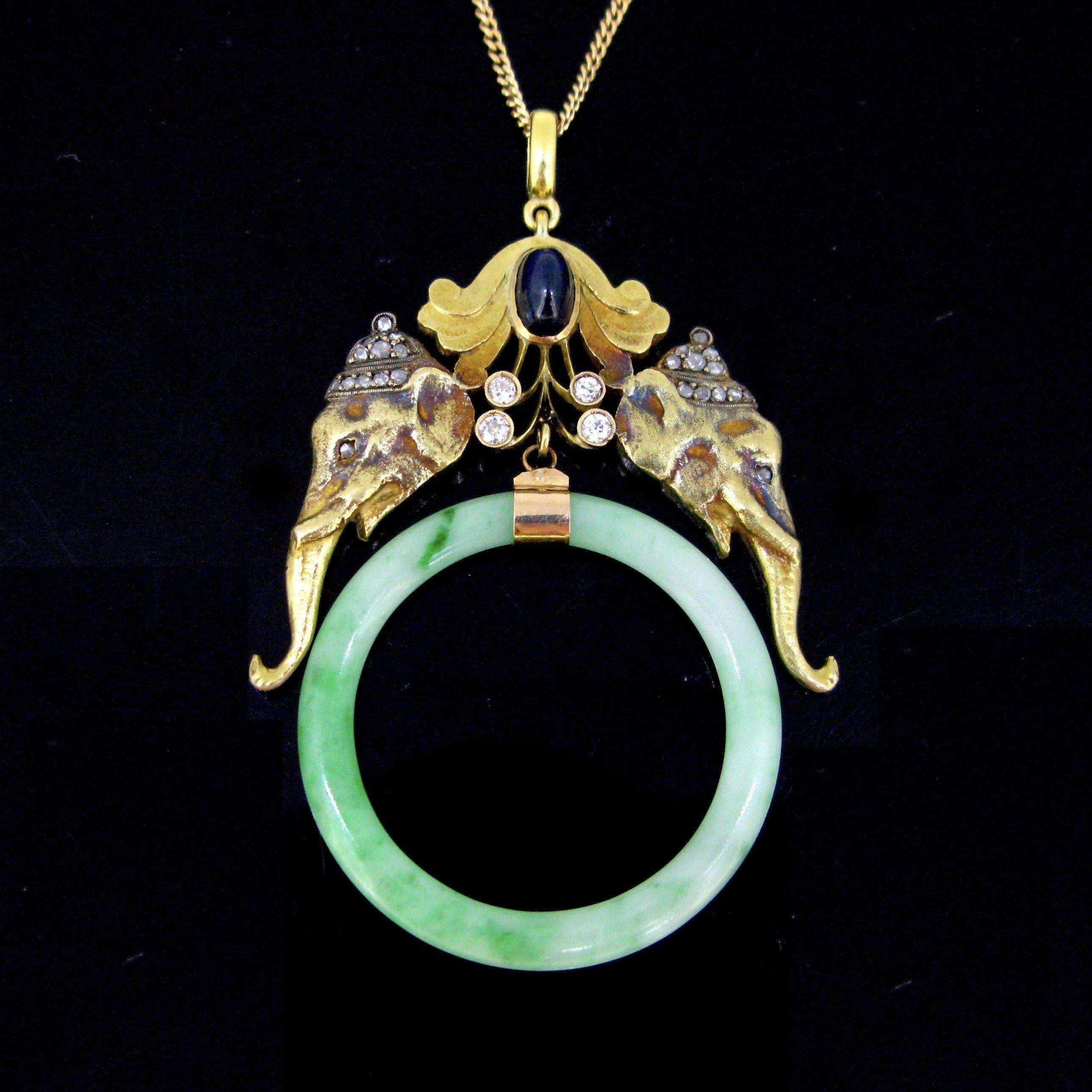 Weight: 22,8gr

Metal: 18kt Yellow Gold

Condition: Very Good

Stones: 1 Sapphire
• Cut: Cabochon
• Weight: 2ct approximately

Others: 28 diamonds (tcw: 0.50ct approximately)
Jadeite jade

Comments: This pretty pendant is fully made in 18kt solid