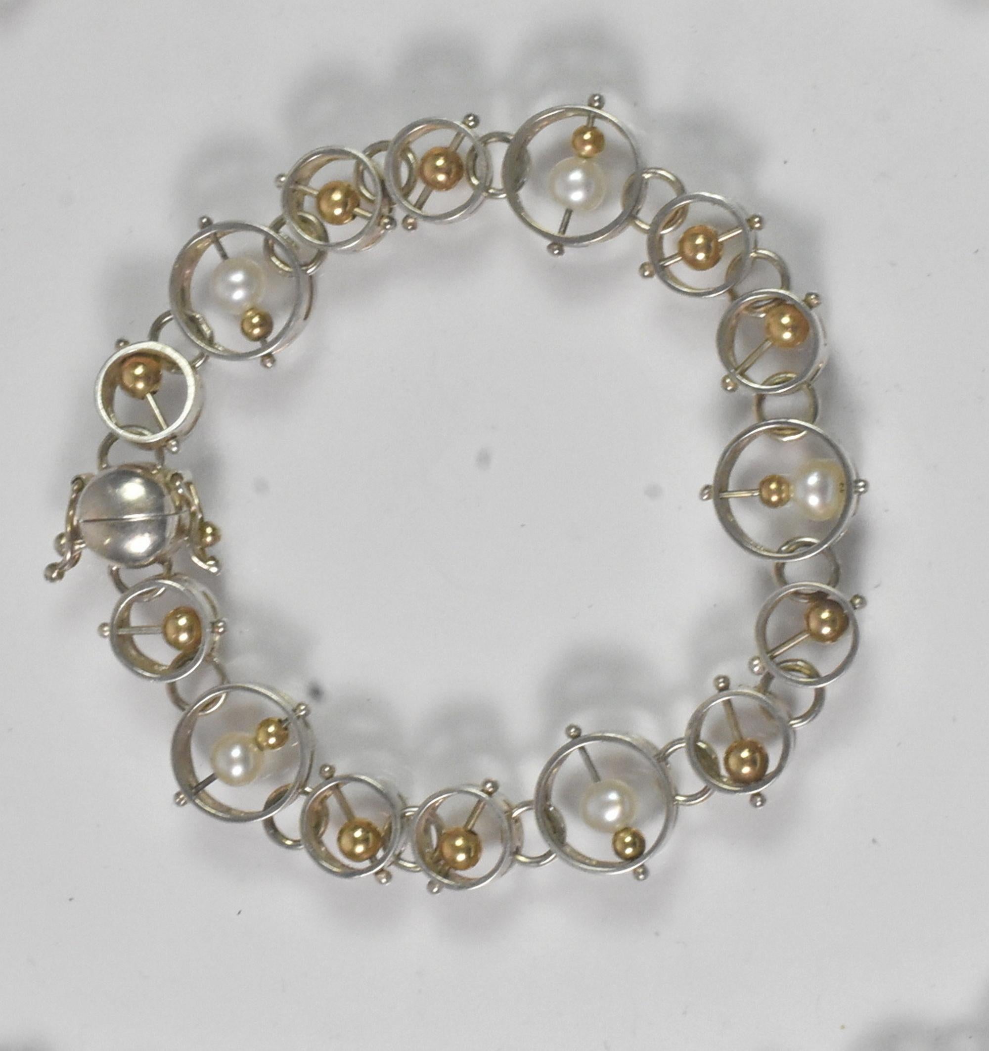 Vintage Dian Malouf (DLM) sterling & 14k gold modernist necklace & bracelet set. Rare floating 14K yellow gold beads and pearls set in circles of sterling. Bracelet held with a magnet and locking clasps. Great condition in a unique look. Hallmark