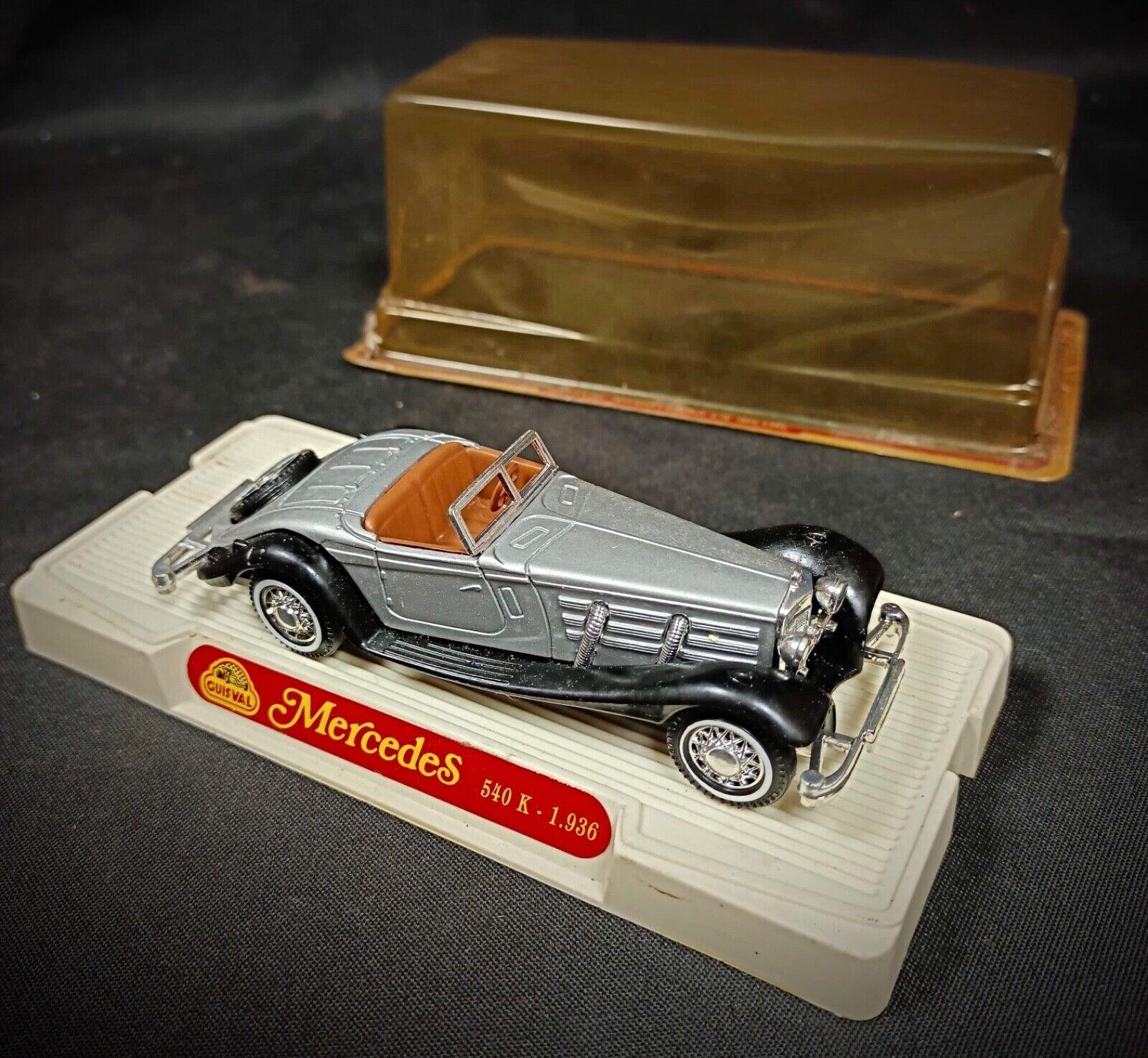 Enhance your collection with this vintage die-cast model of the Mercedes 540K from 1936, complete with its original box. This collectible model car is a stunning representation of classic automotive design, rendered in a sleek grey finish.

In good