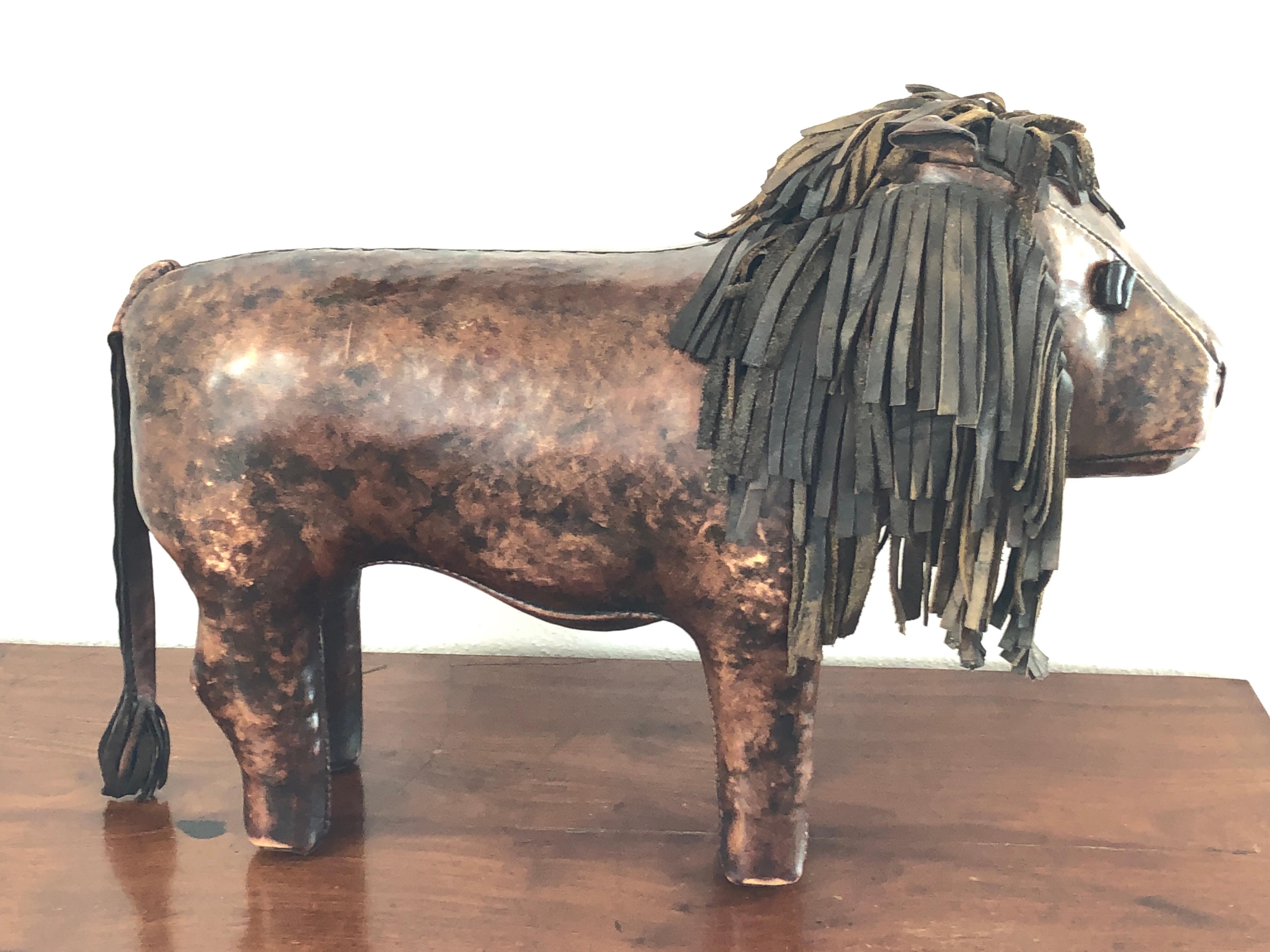 Vintage Dimitri Omersa lion footstool with light wear and patina on the leather consistent with wear and age.

  