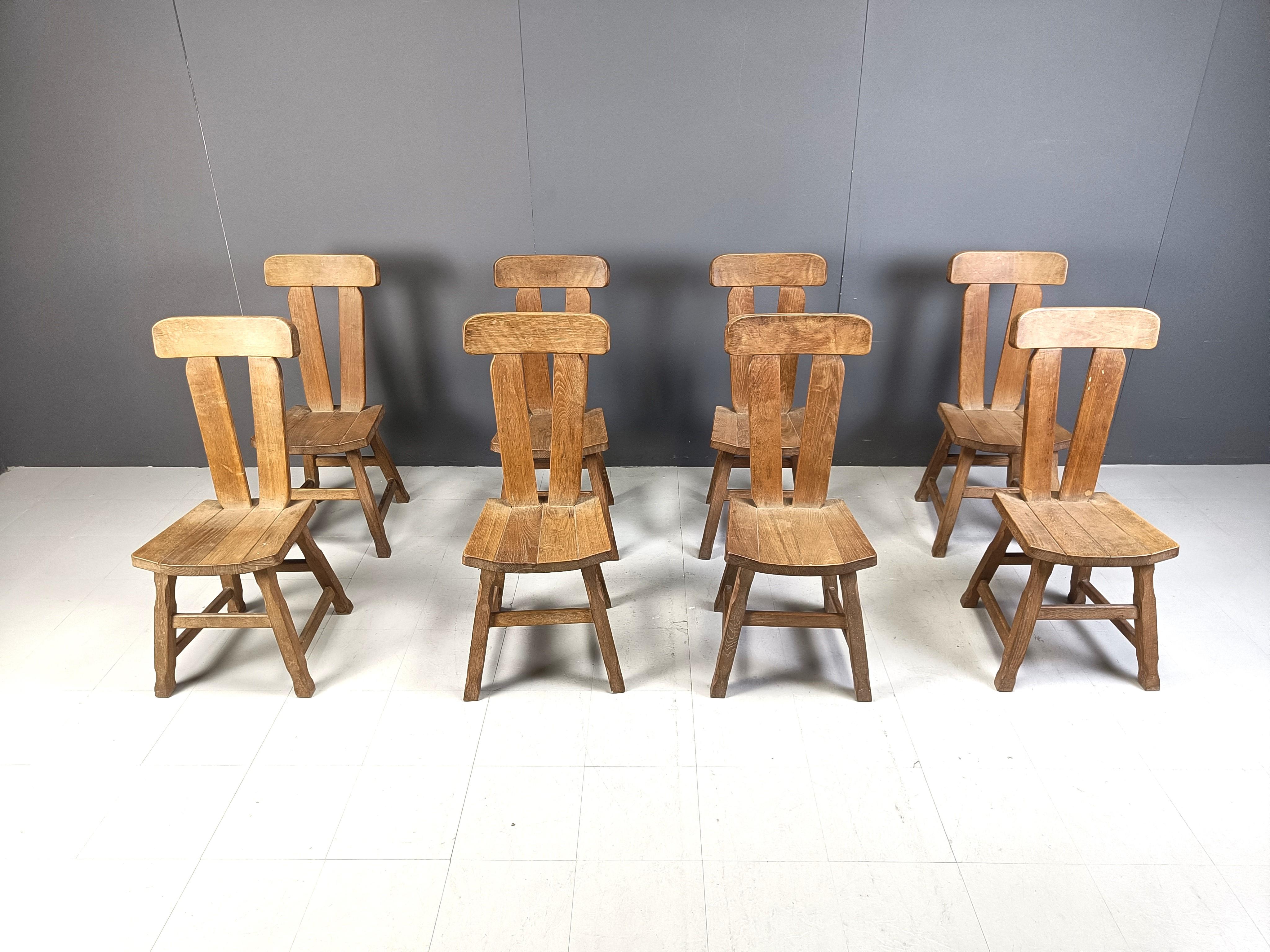 Set of 8 sturdy and handcrafted dining chairs produced by Depuydt Kunstmeubelen in Belgium.

The chairs are made from solid oak.

Beautiful split backs with interlocking wooden pieces.

These chairs will last for ages.

Good condition.

1960s -