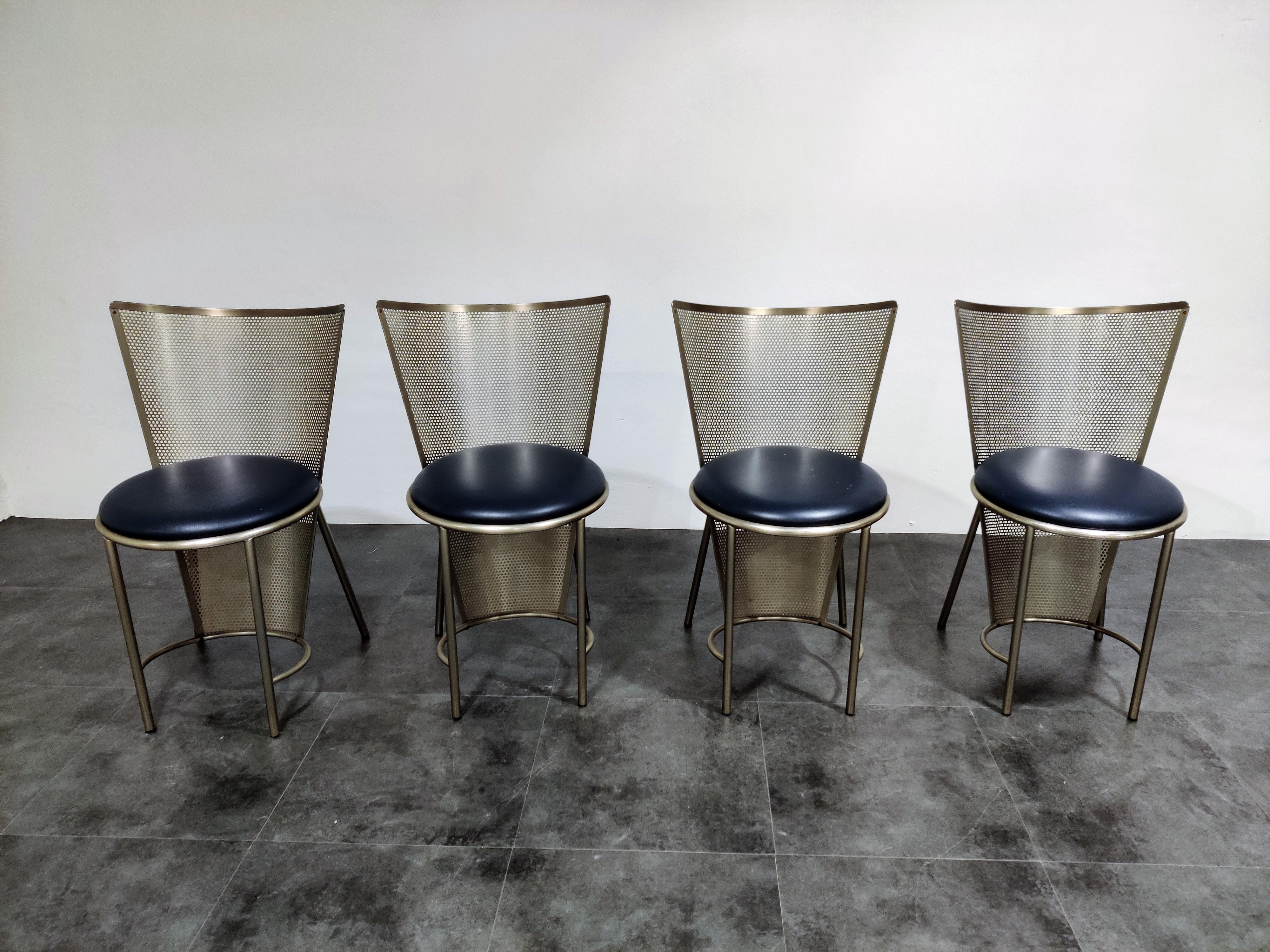 Set of four perforated metal dining chairs designed by Frans Van Praet for belgochrom.

These chairs where designed for the world expo of 1992 in Sevilla.

The chairs have a beautiful geometric design and the seats have blue upholstery.

The