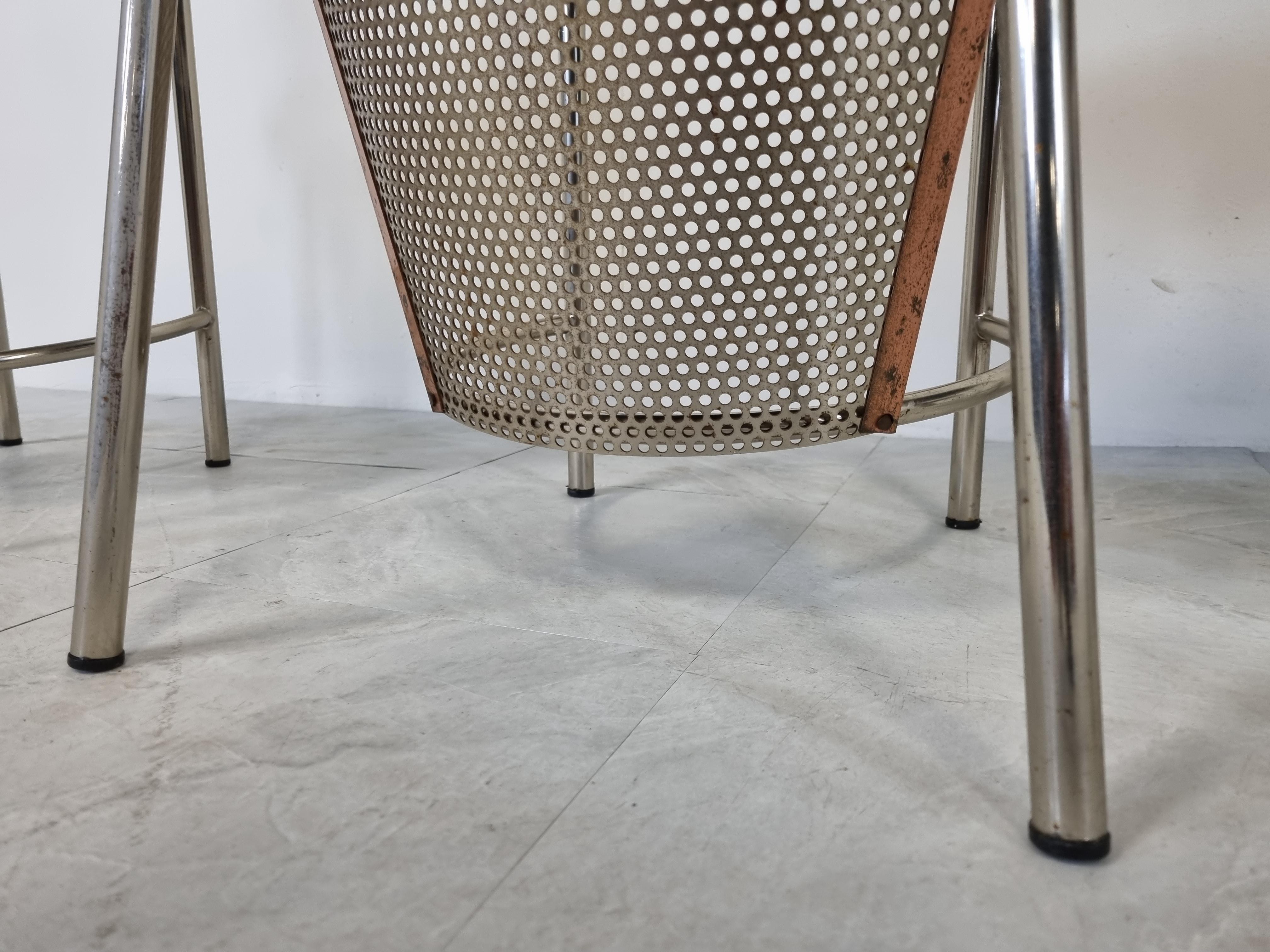 Set of four perforated metal dining chairs designed by Frans Van Praet for belgochrom.

These chairs where designed for the world expo of 1992 in Sevilla.

The chairs have a beautiful geometric design and the seats have white upholstery.

The