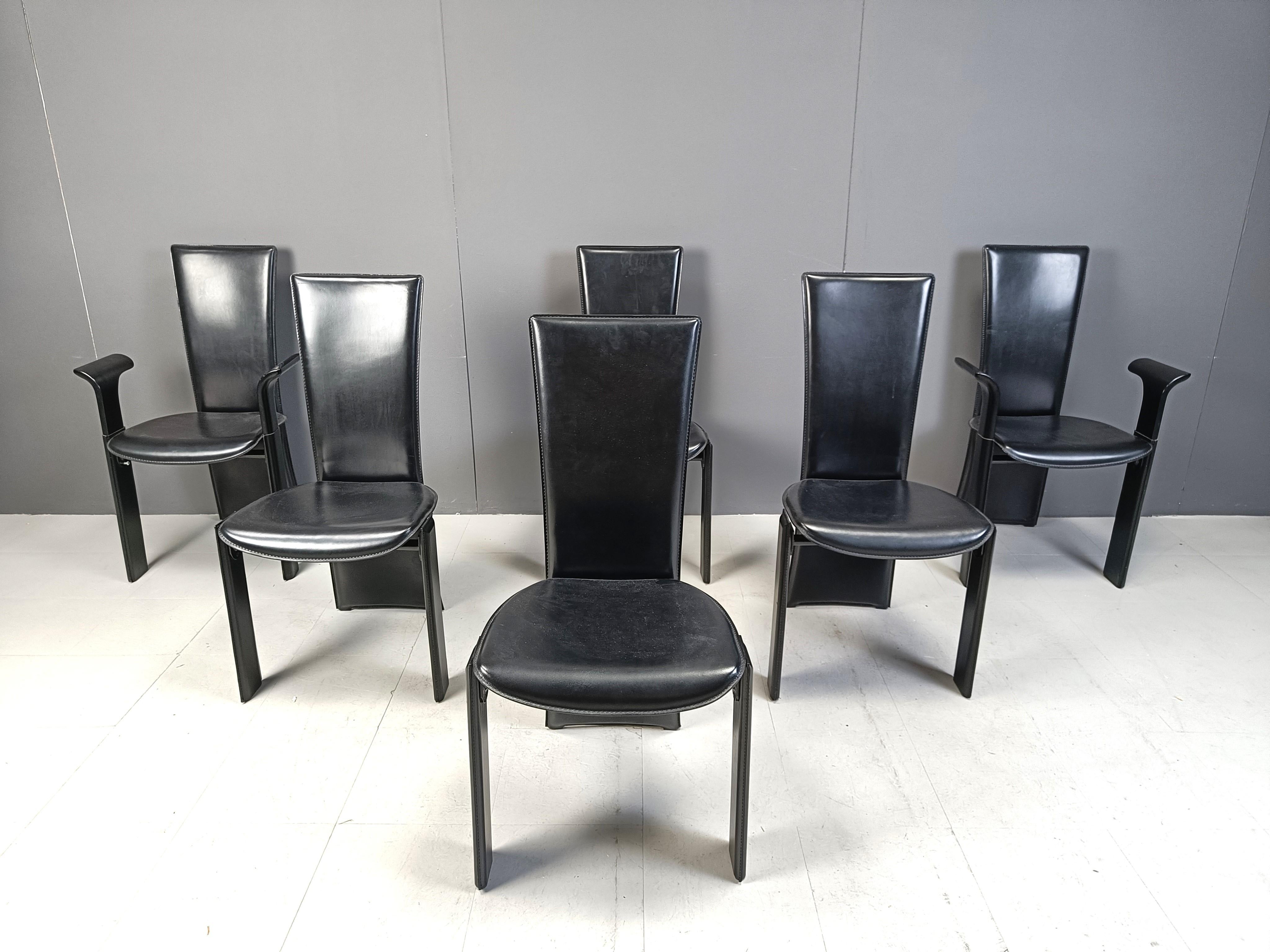 Very chic italian high back dining chairs designed by Pietro Costantini.

Elegant curved lacquered wood backrests and upholstered with black leather. 

Two of the chairs have armrests.

Stamped under thea seat with 'Pietre Costantini'

Good