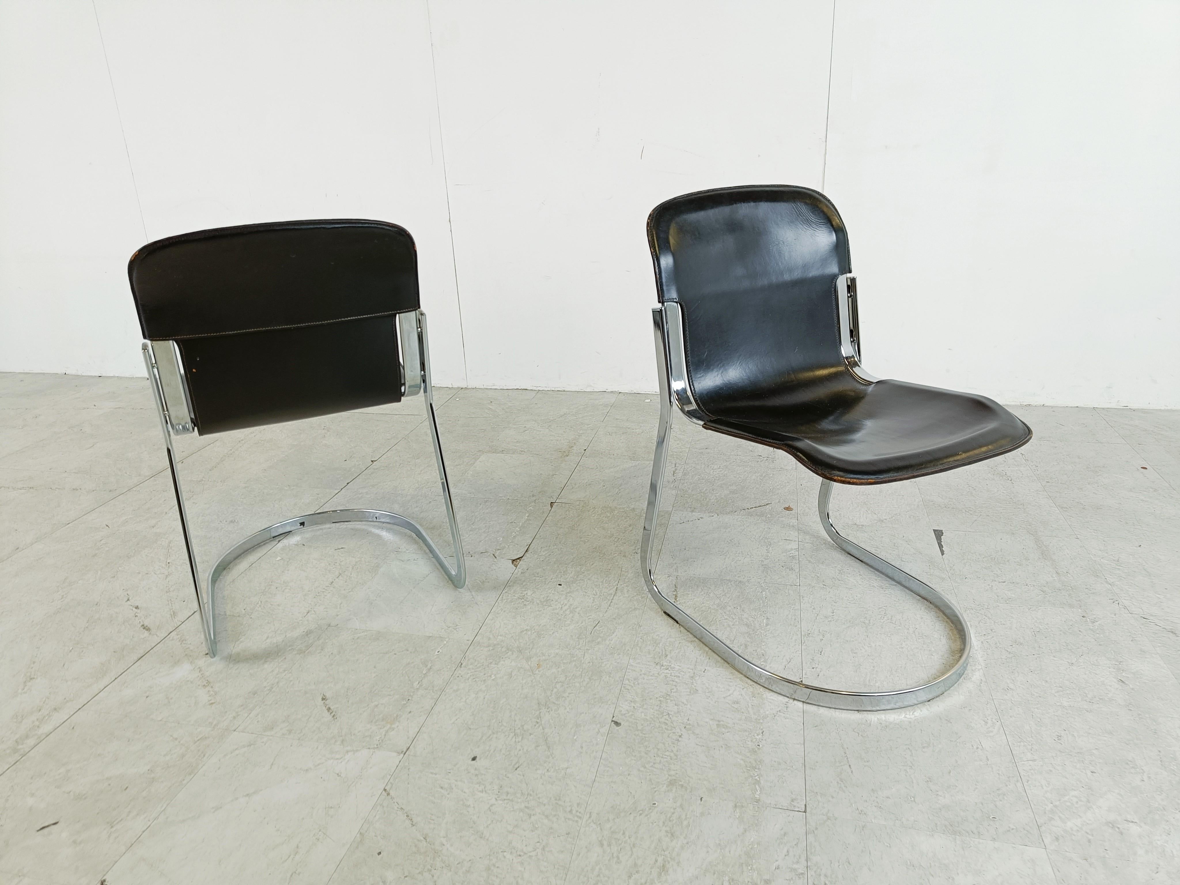 Set of 6 dining chairs designed by Willy Rizzo for Cidue.

The chairs have a beautyfully shaped chrome frame and come with the original black leather seats.

Good condition, normal age related wear/patina.

The chairs still look up to date in modern