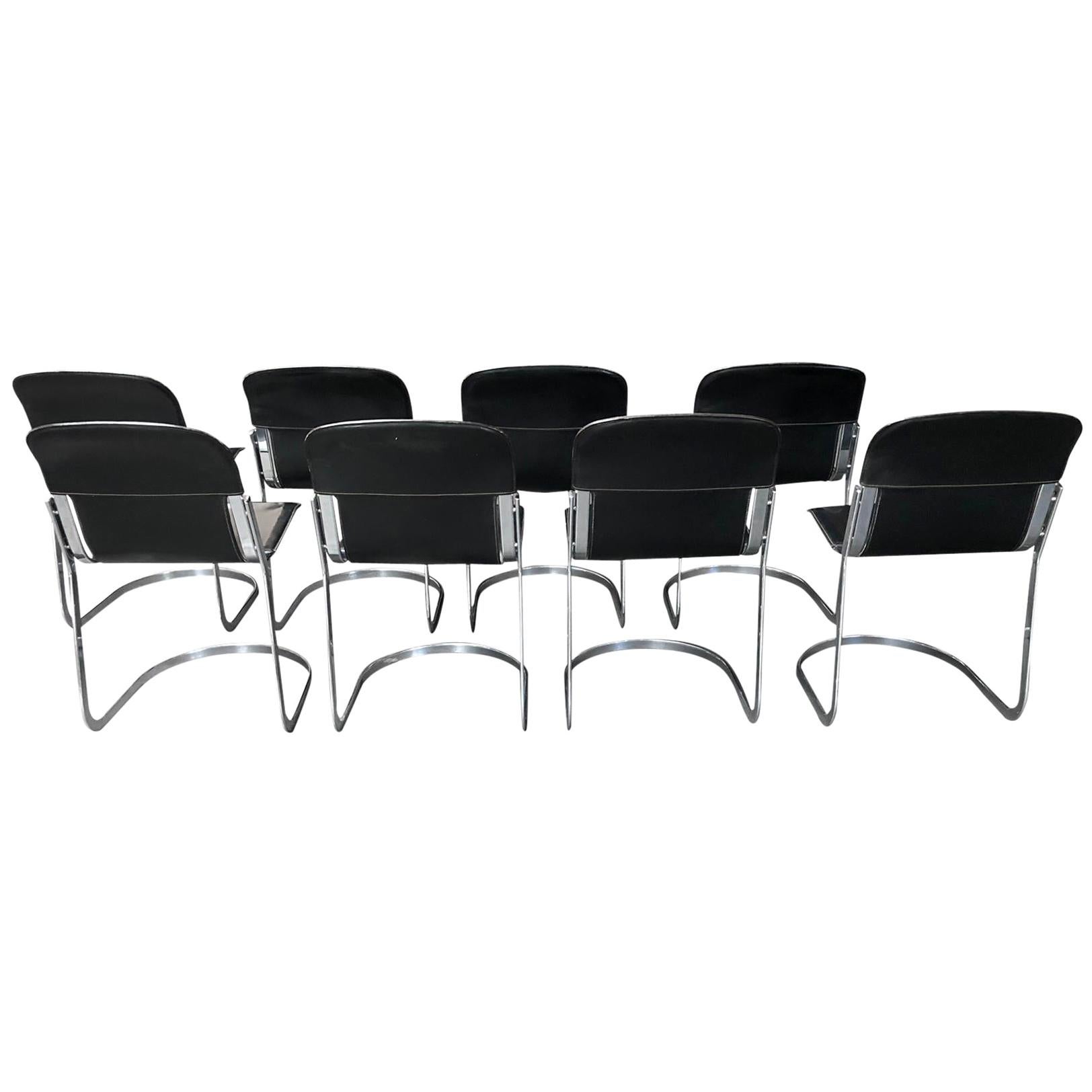 Set of 8 dining chairs designed by Willy Rizzo for Cidue (model C2).

The chairs have a beautifully shaped chrome frame and come with the original black leather seats.

The chairs are stackable.

Very good condition, no discoloration, no