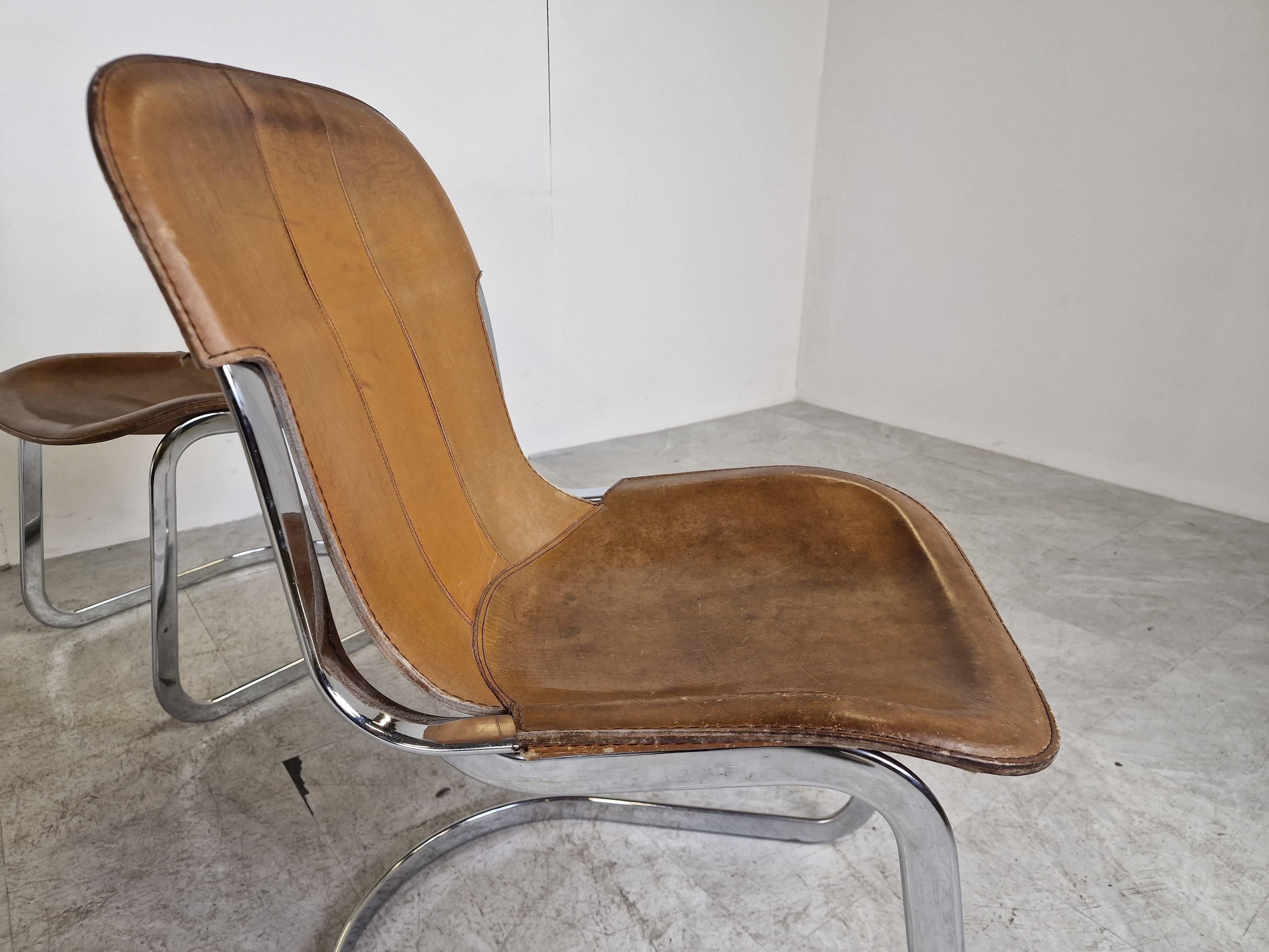 Set of 8 dining chairs designed by Willy Rizzo for Cidue.

The chairs have a beautyfully shaped chrome frame and come with the original tan leather seats.

Used condition, leather shows wear, but still look very attractive. Frames have been