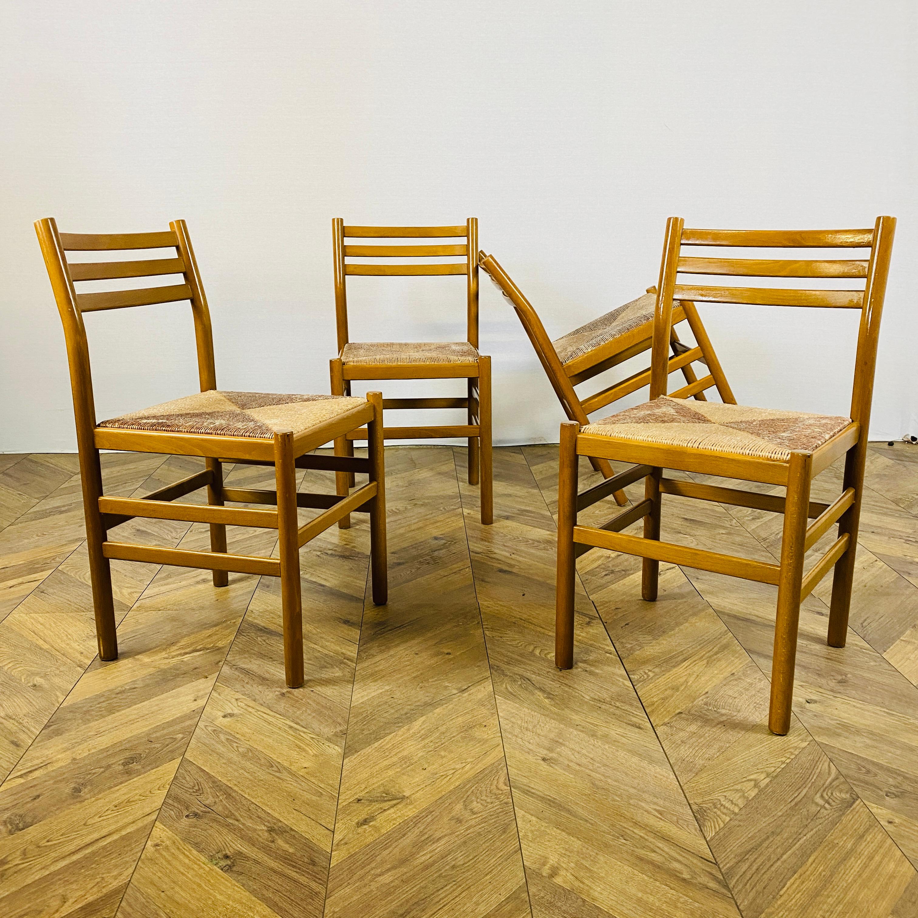 A set of 4, Vintage dining chairs, circa 1970s.

In the design style of Gio Ponti, the chairs are structurally strong but in-keeping with their age do have small scuffs to the frames. The seats are made from paper cord, which are all in good