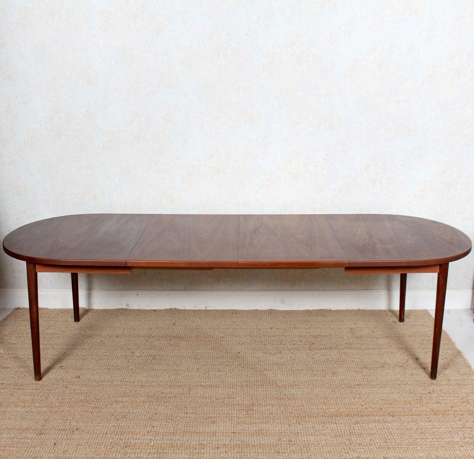 An impressive mid-20th century Swedish dining table designed by Nils Jonsson and manufactured by Hugo Troeds.
The shaped top raised on bolted shaped tapering legs and extending by way of two spare leafs. Fully extended the piece seats 10-12