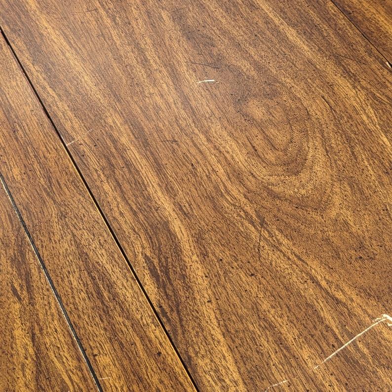 This vintage dining table by Broyhill exudes classic elegance and timeless charm. Crafted with high-quality materials and meticulous attention to detail, this table features a rich finish and intricate carved details that add a touch of