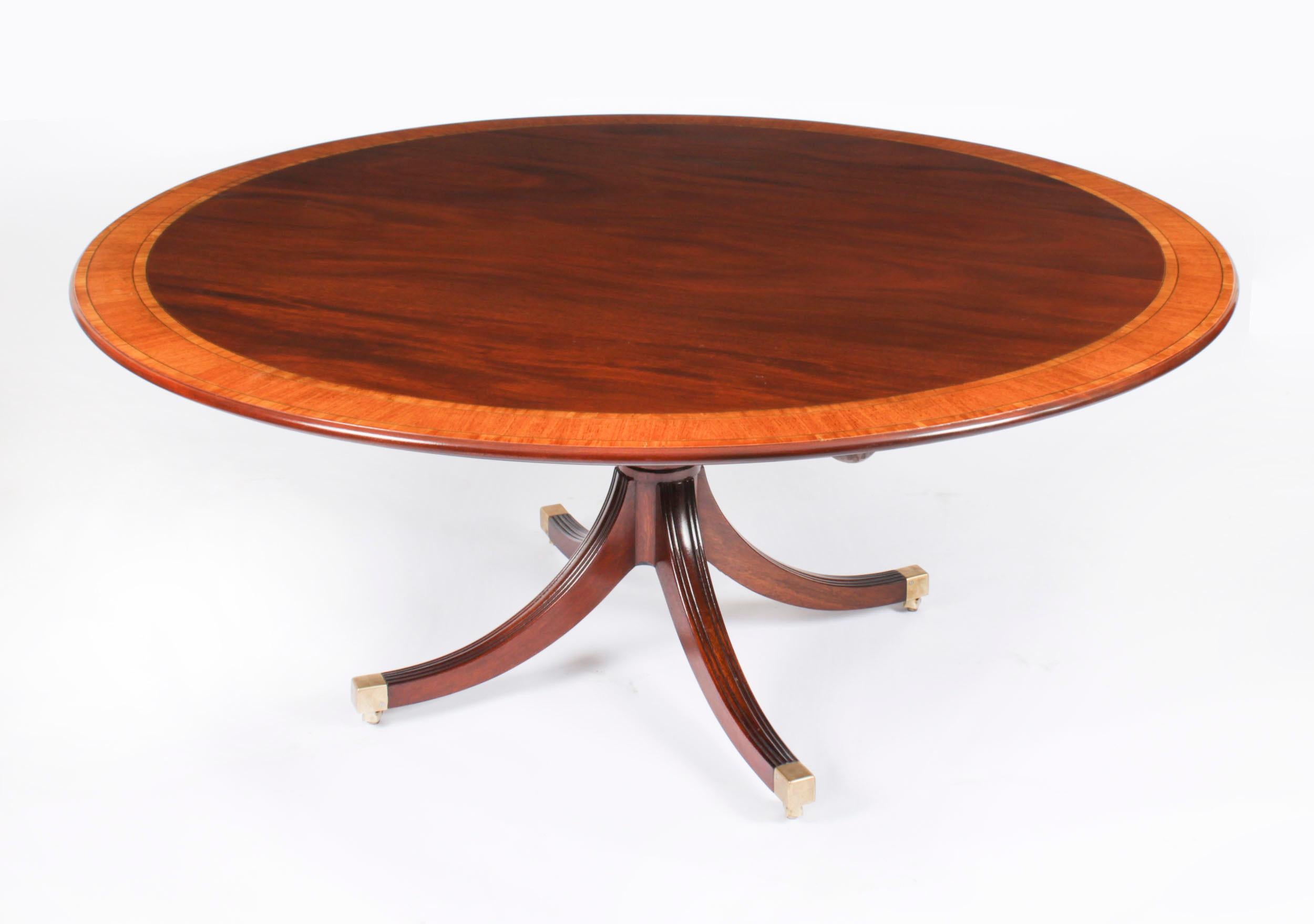 This is a beautiful Regency Revival flame mahogany and Satinwood banded dining suite  dating from Circa 1980, made by the Master Cabinet maker William Tillman and bearing his label on the underside,comprising a circular dining table with the