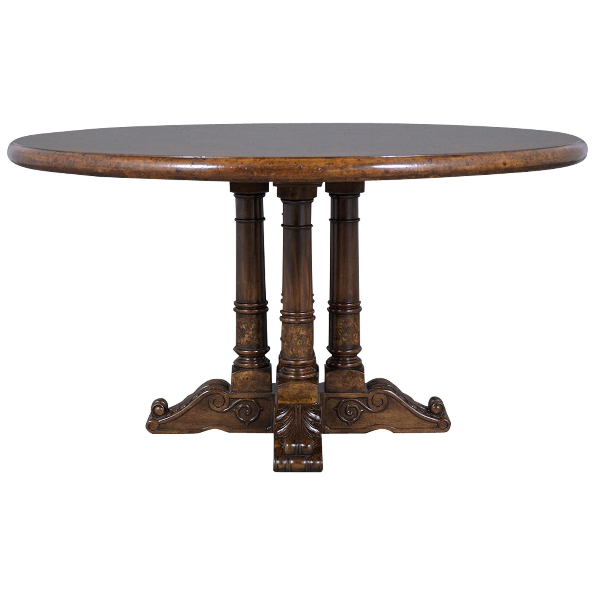 An excellent vintage empire-style dining table hand-crafted out of solid wood covered with birch-eye veneers and has been professionally restored. This fabulous circular dining table features a new dark walnut color with a lacquer finish and a