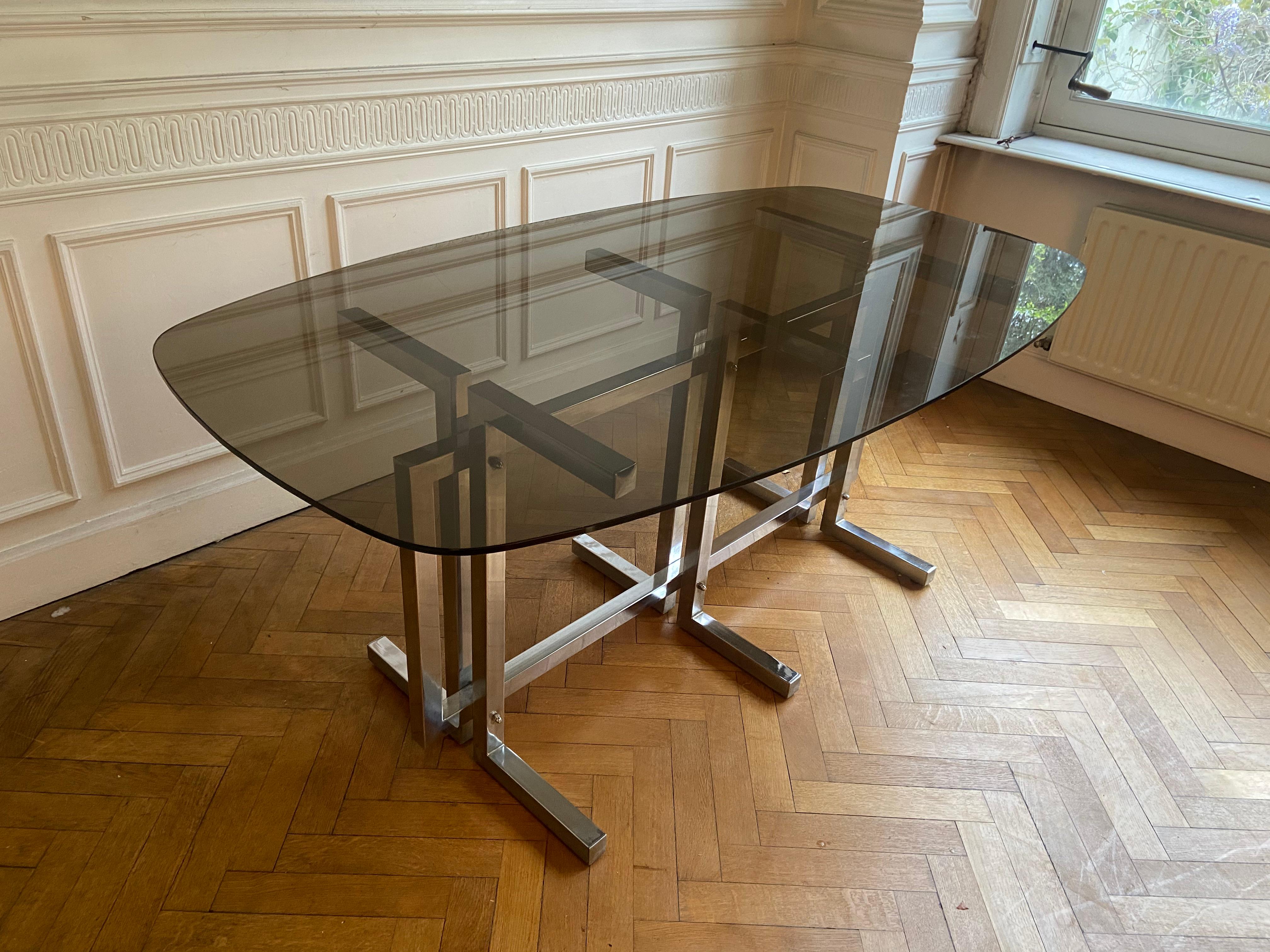 Vintage dining table. Graphic feet in chrome metal. Smoked glass top. 4