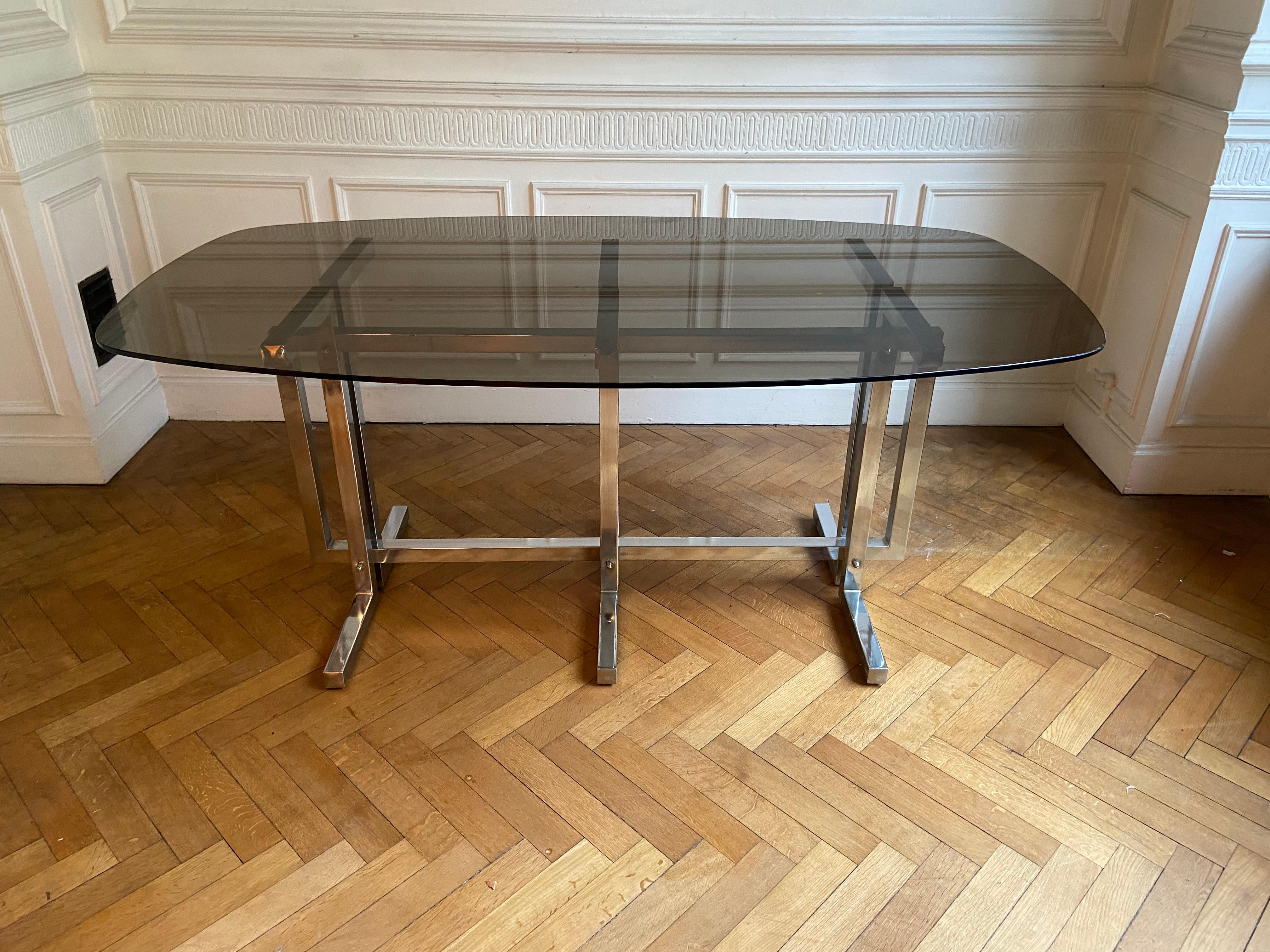 Mid-Century Modern Vintage dining table. Graphic feet in chrome metal. Smoked glass top.