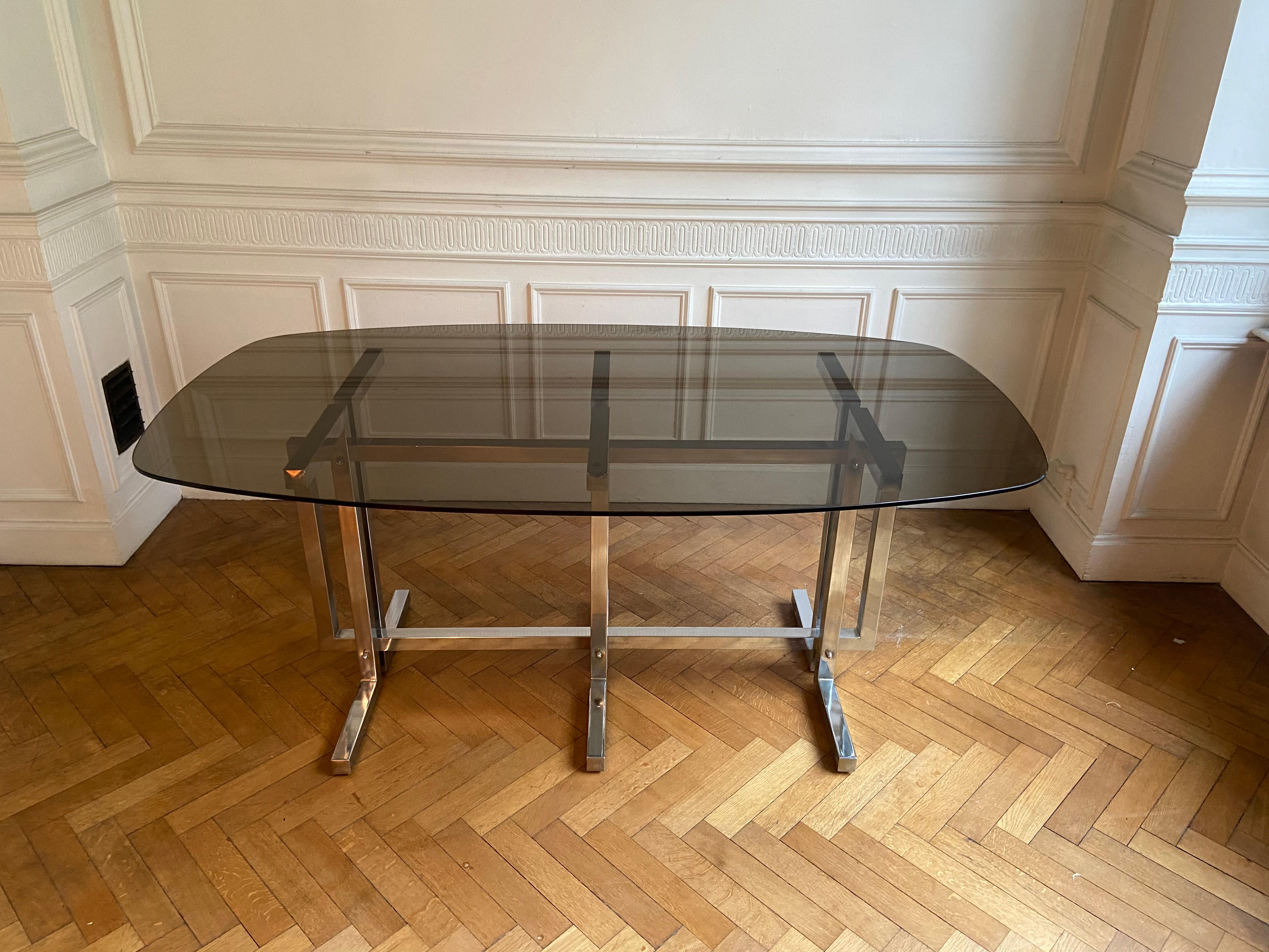 European Vintage dining table. Graphic feet in chrome metal. Smoked glass top.