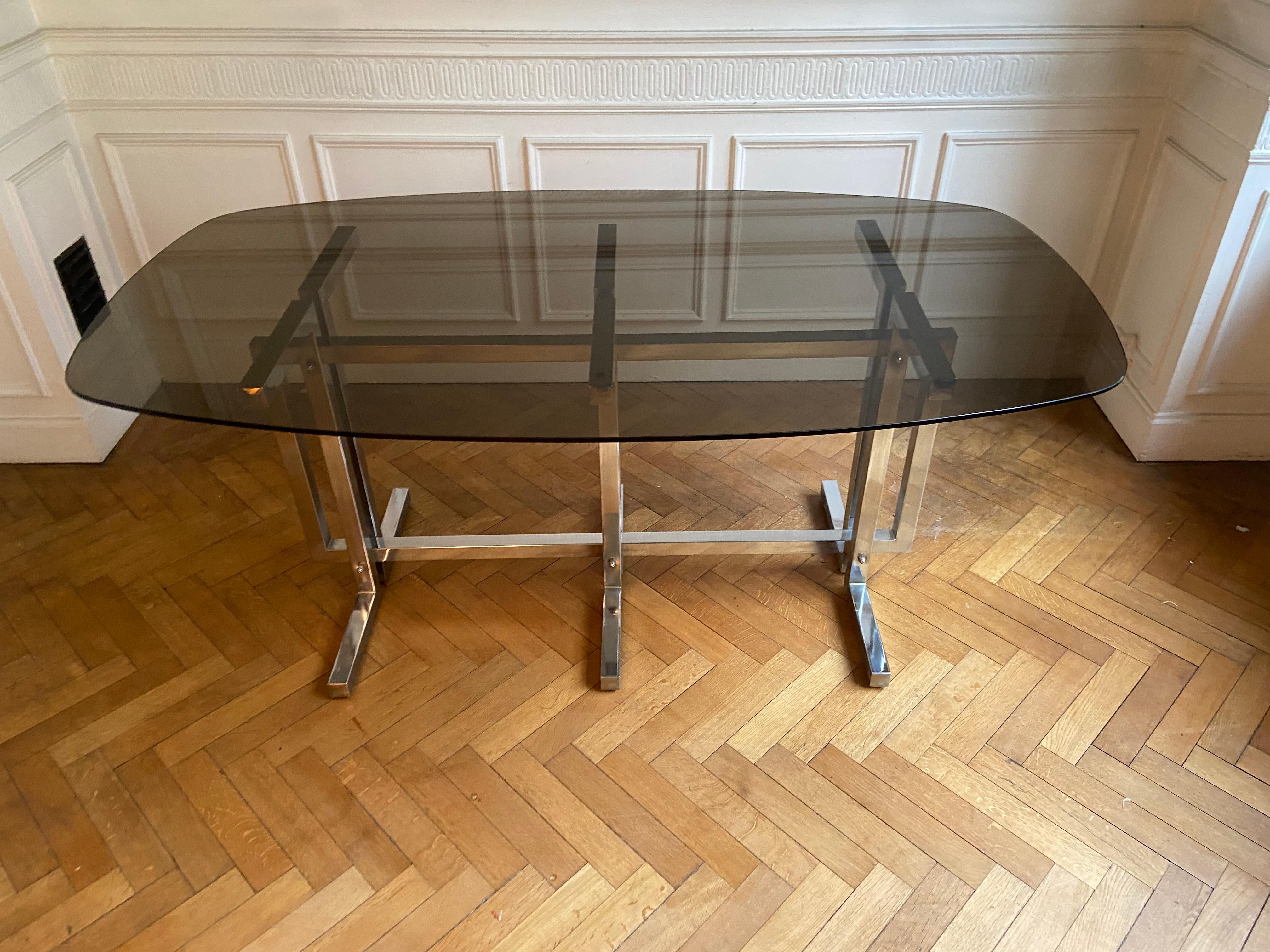 20th Century Vintage dining table. Graphic feet in chrome metal. Smoked glass top.