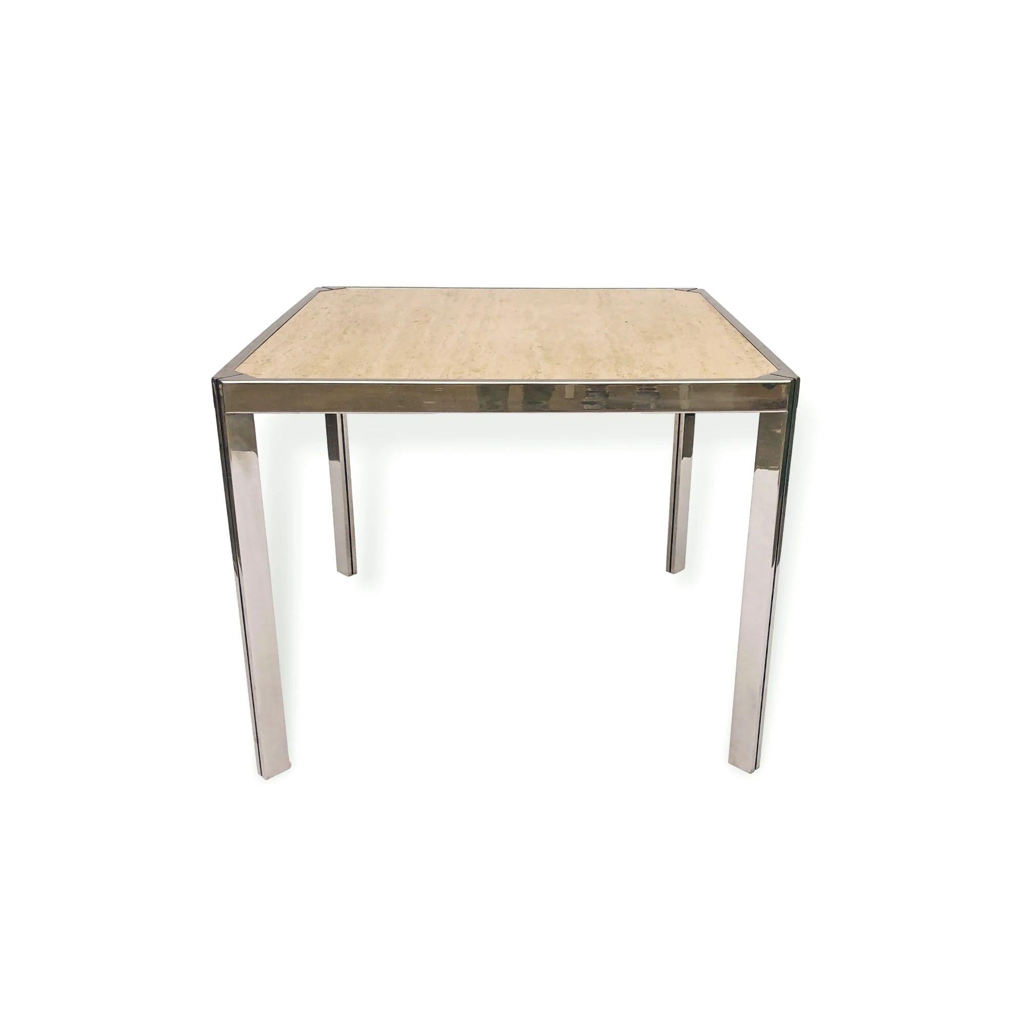 This vintage mid century square travertine and nickel game table or small dining table in the style of Milo Baughman or Willy Rizzo was made in France circa 1970. The sleek, minimalist design features a polished nickel-plated steel frame with 45