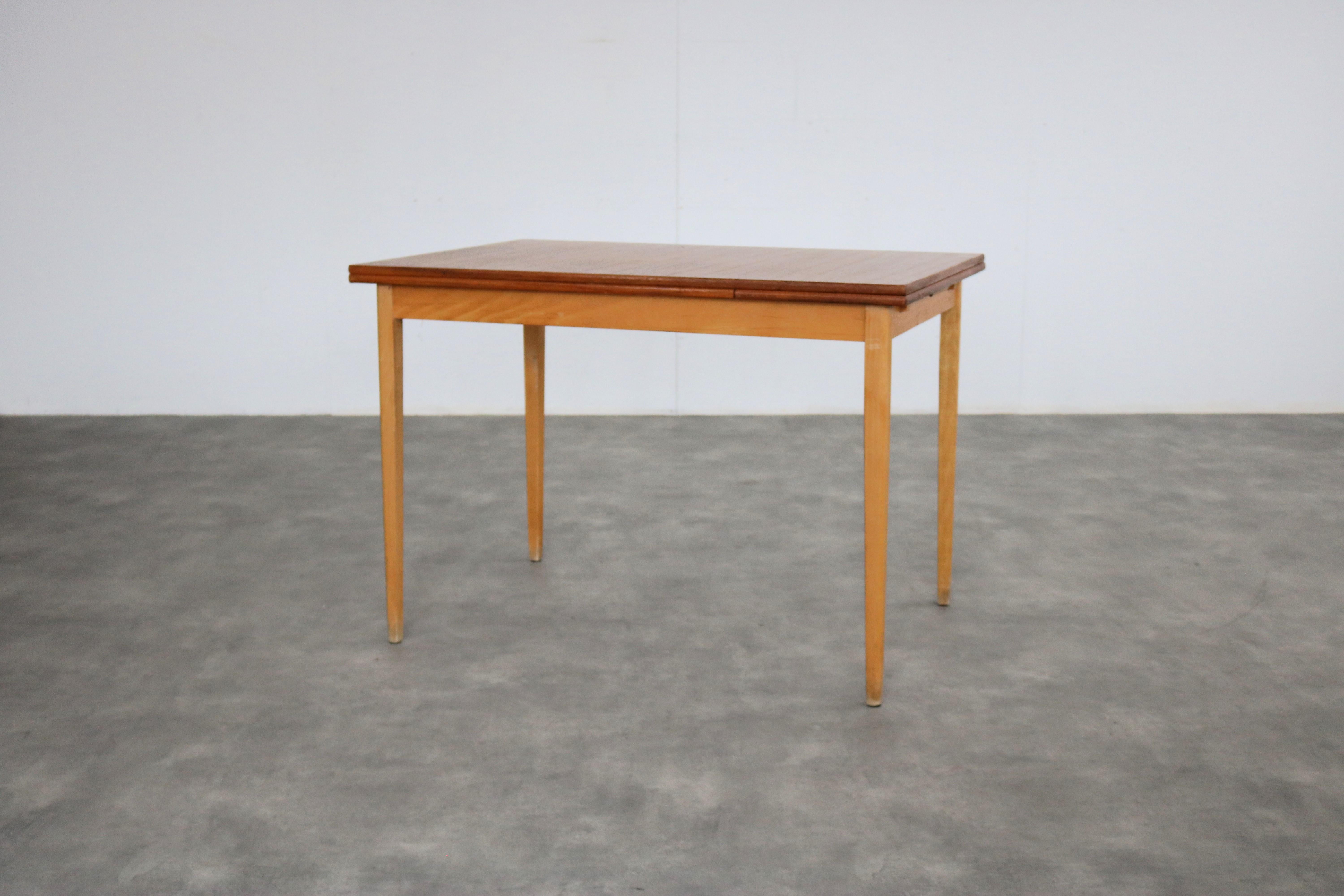vintage dining table  table  extendable  60s  Swedish

period  1950s
design  unknown  Sweden
condition  good  light signs of use
size  75 x 105 x 75 (hxwxd) + 1 pull-out tray of 30 cm;

details  oak; teak; extendable; 

article number  2588