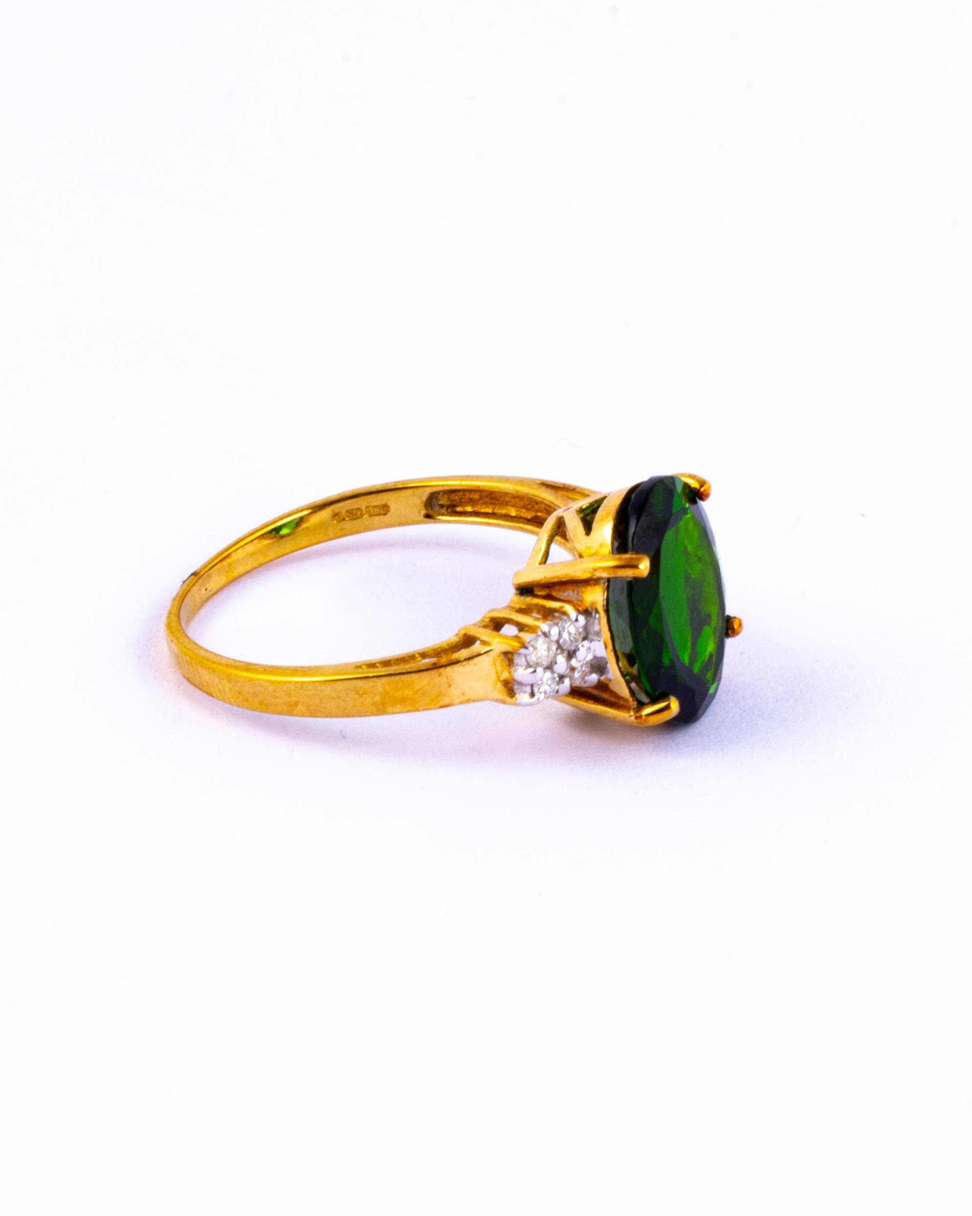 The deep green diopside sits perched up high on a simple claw setting with an open work gallery. The shoulders have diamonds which total approx 10pts. Modelled in 9ct gold. 

Ring Size: N or 6 3/4 
Stone Dimensions: 11x9mm
Height Off Finger: 6.5mm