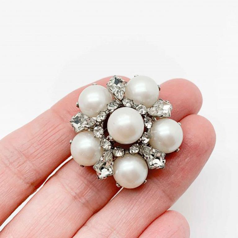 A beautiful 1966 Vintage Dior Pearl Brooch cleverly emulating the look of diamonds and pearls. The Austrian crystals in this piece are incredibly bright and catch the light perfectly and the whole glass faux pearls exude a wonderful luminescence