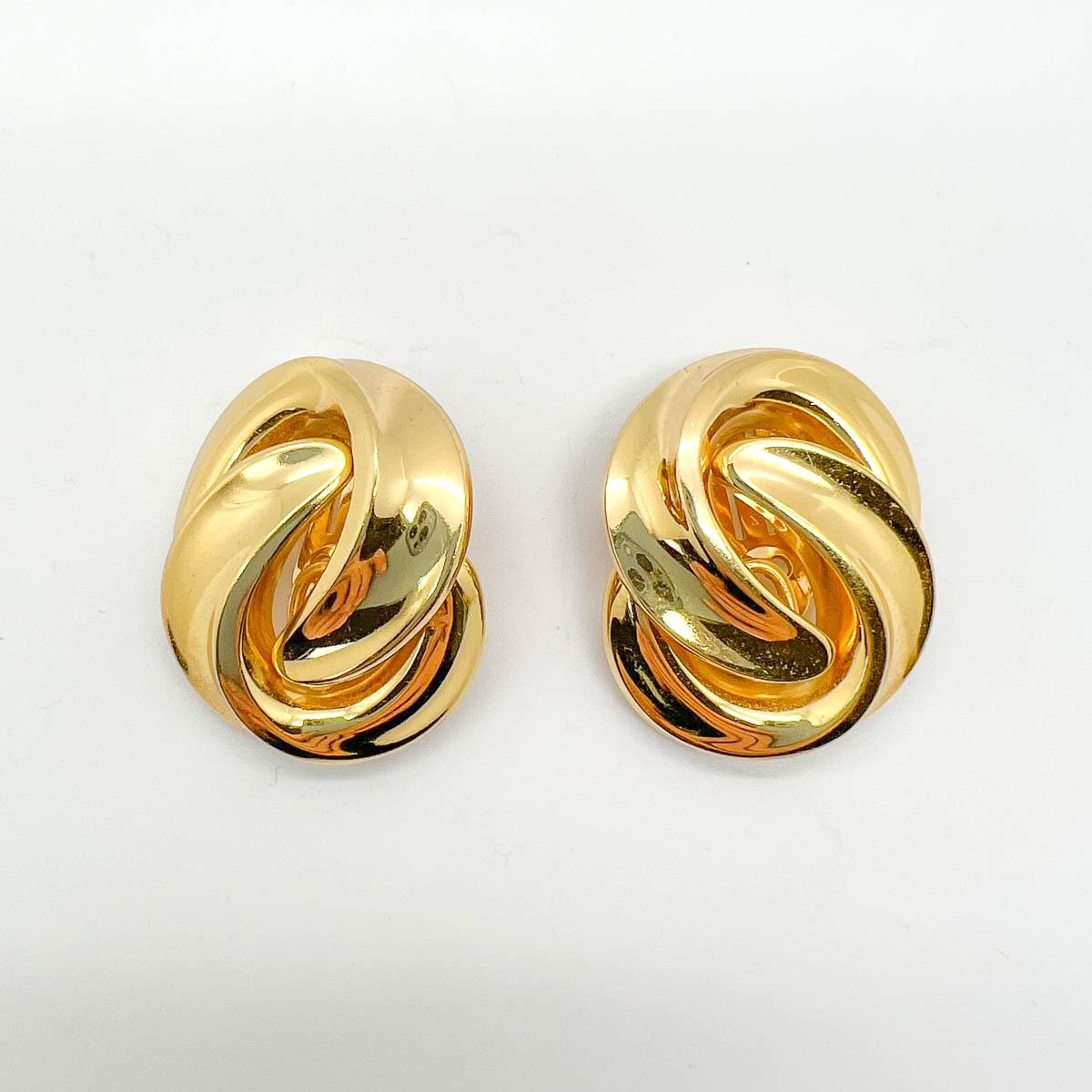A pair of vintage Dior Grande Love knot Earrings. A simply stunning take on the smaller love knot earrings from this era. Large enough to make a grand statement, the lustrous high shine gold plate will perfect your look every time. The perfect