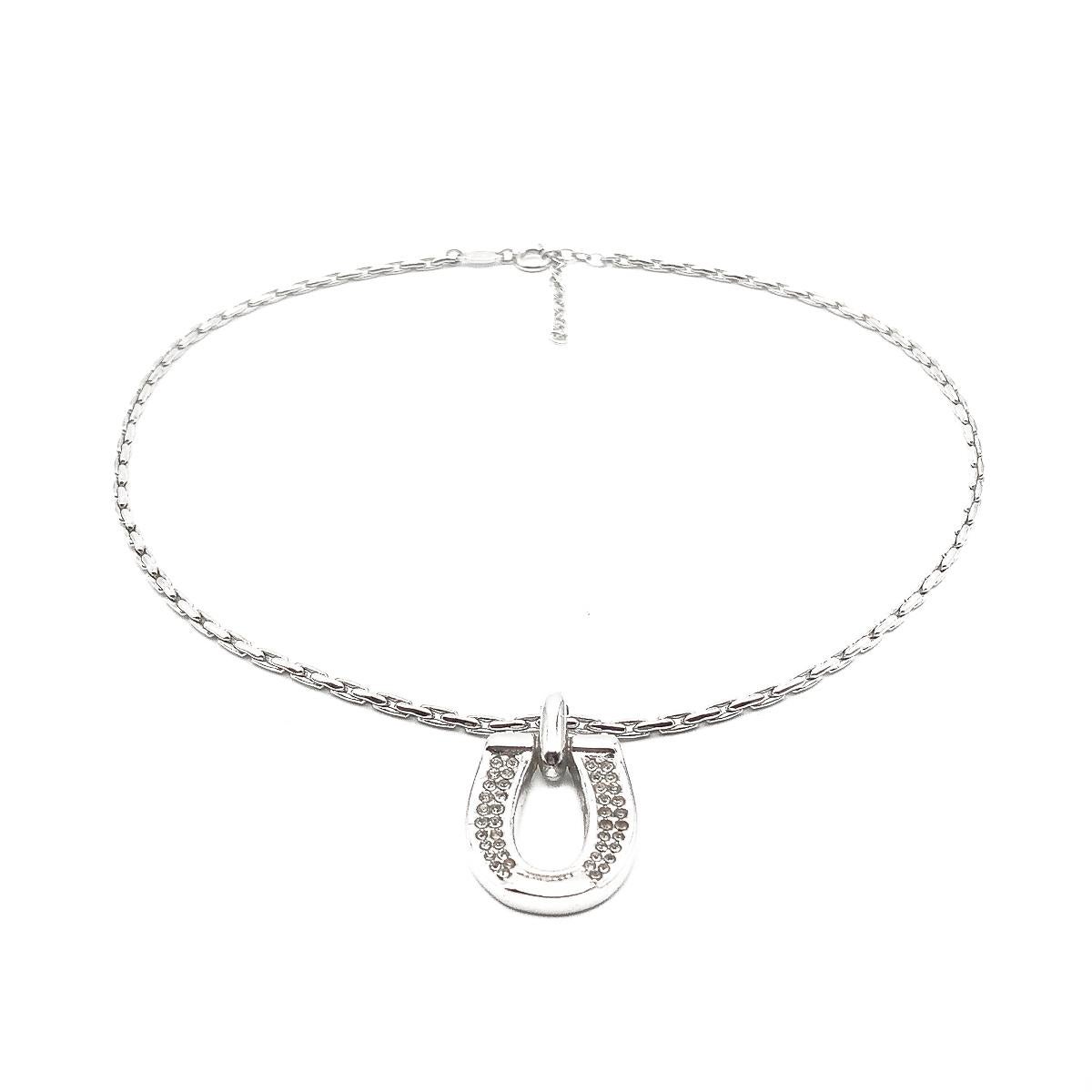 A vintage Dior Horseshoe necklace. Featuring a crystal set horseshoe on a fancy chain.
Vintage Condition: Very good without damage or noteworthy wear. 
Materials: Rhodium plated metal, glass crystals
Signed: Dior
Fastening: Bolt ring
Approximate
