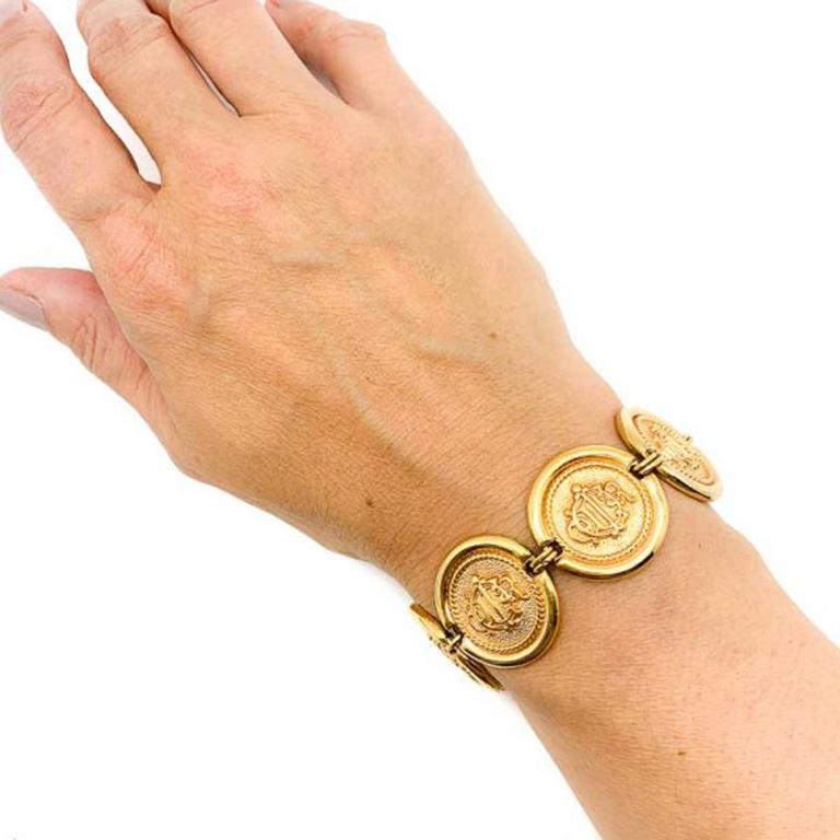 A high on style Vintage Dior Interlocked Monogram Bracelet from the 1980s. Featuring seven stunning gold plated discs bearing the interlocked Dior Logo, originally conceived by the house during the 1950s. The same logo resurrected in the 1980s.