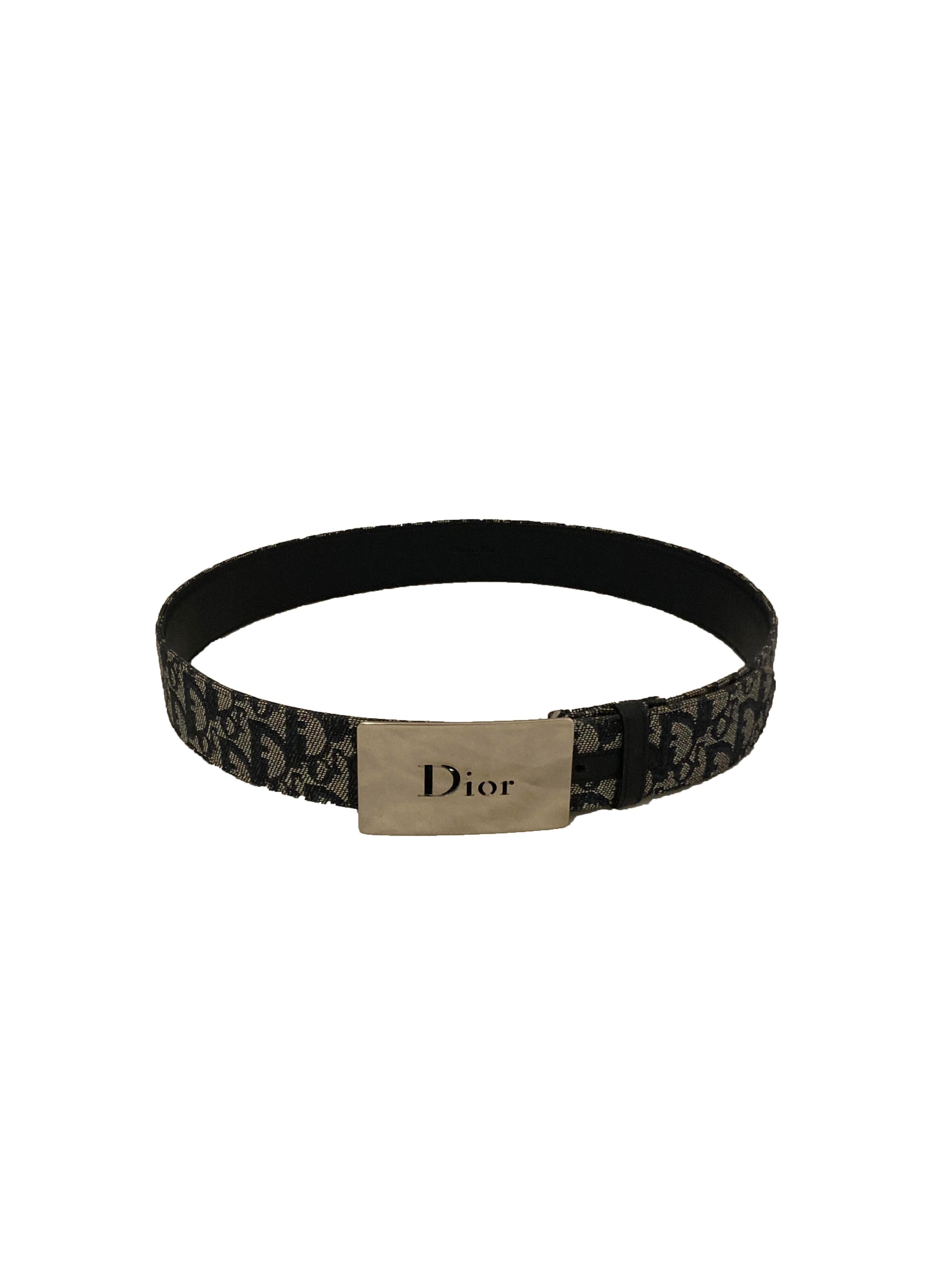 Vintage Oblique canvas belt from Dior. Ecru with navy stitching creating an all over 'Dior' motif. With rectangular silver toned metal buckle branded 'Dior' in cut out lettering. With nay leather belt loop and trim. Made in Italy. Marked size 90.