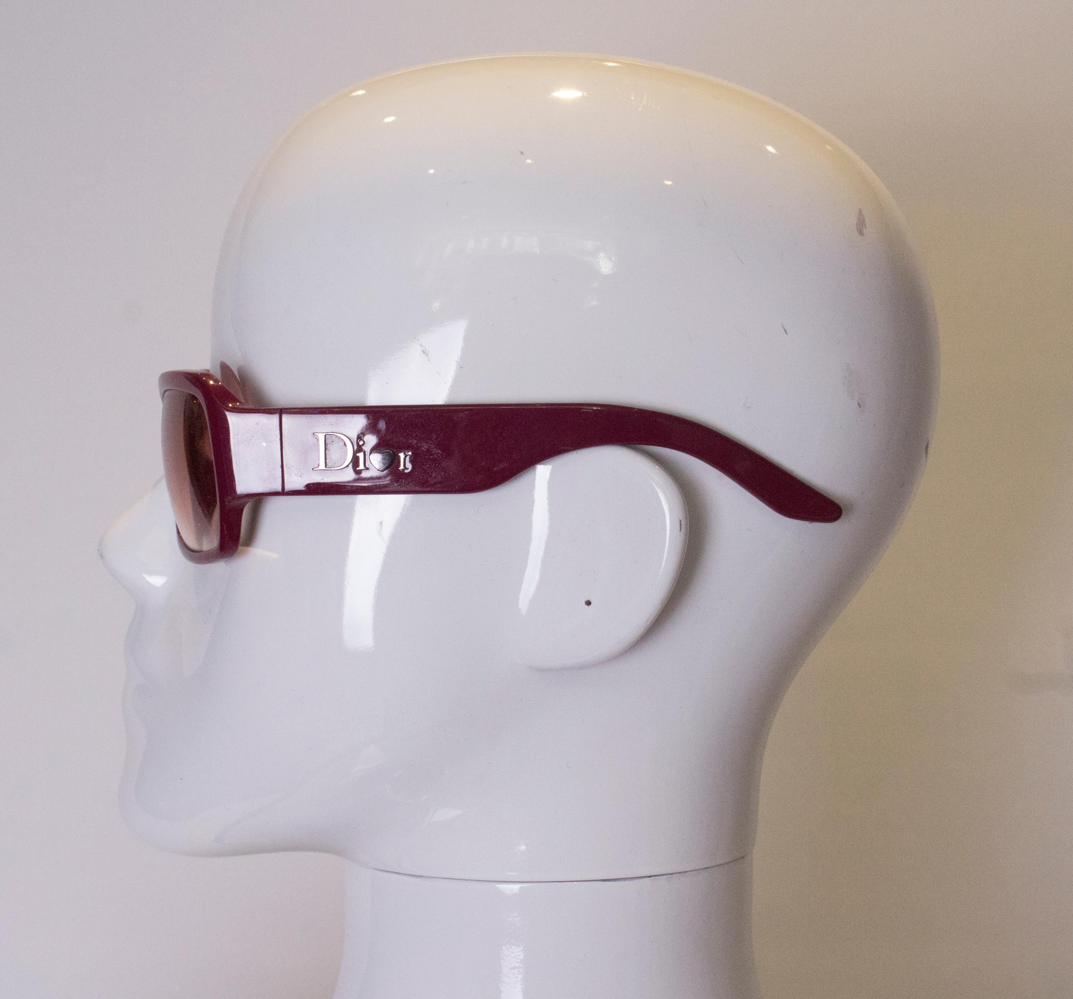 A pair of vintage Dior sunglasses  in a stunning purple colour. The glasses were made in Italy.