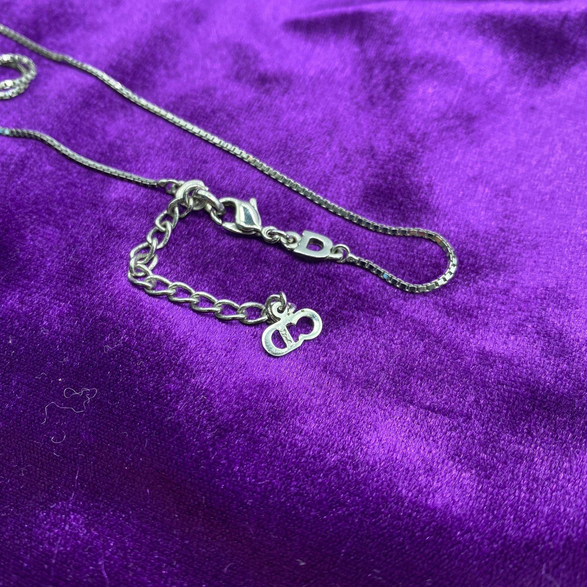Vintage Dior Necklace Y2K

An iconic John Galliano era Dior piece. Features a silver plated fine box chain with a bronze coloured Dior star pendant.

The Christian Dior aesthetic for timelessly elegant chic originated in the 1940s with the  ‘New