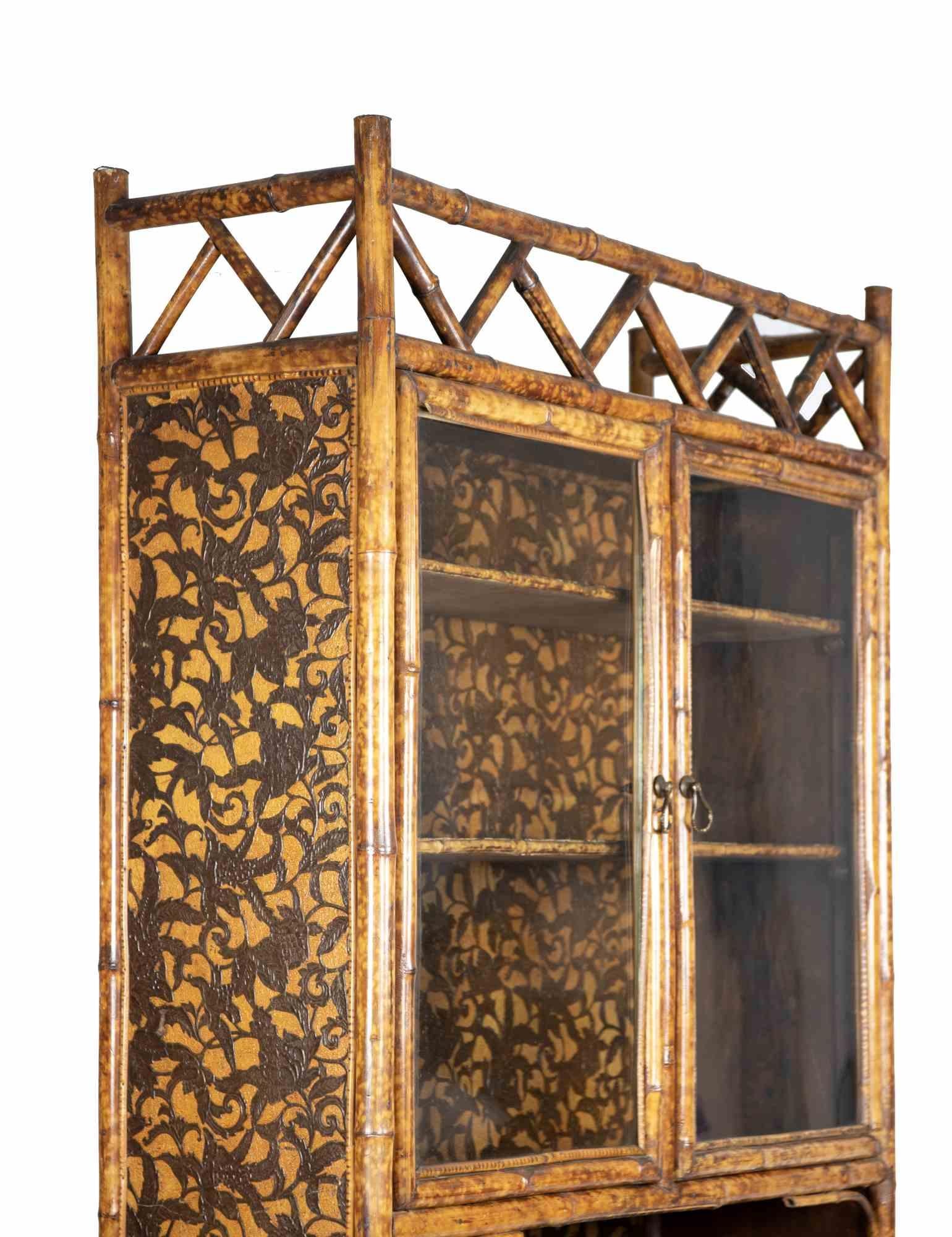 Vintage Display Cabinet is an orginal desgn furniture item realized in the Mid of 20th century.

A very beautiful bamboo cabinet with three shlves in the lower part and an opening door in glass. The cabinet is perfect to preserve your precoius