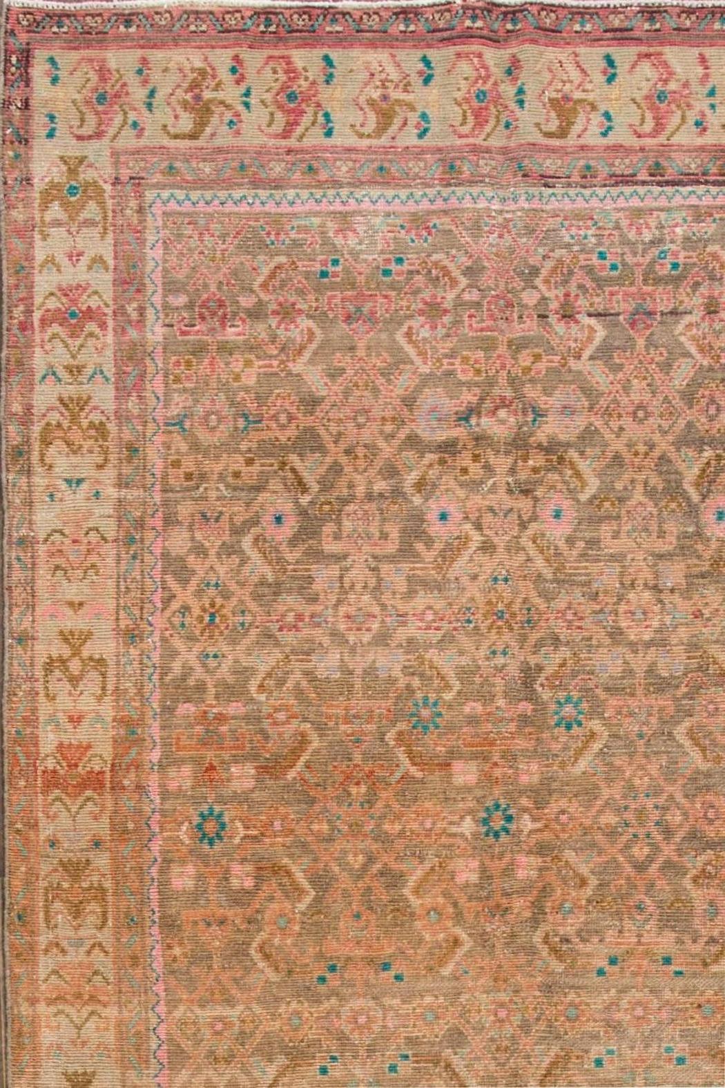 1930s vintage Persian Tabriz carpet. This distressed piece features a beige field and traditional, all-over design in peach tones, accented with blue. Measures: 4.08 x 12.06.