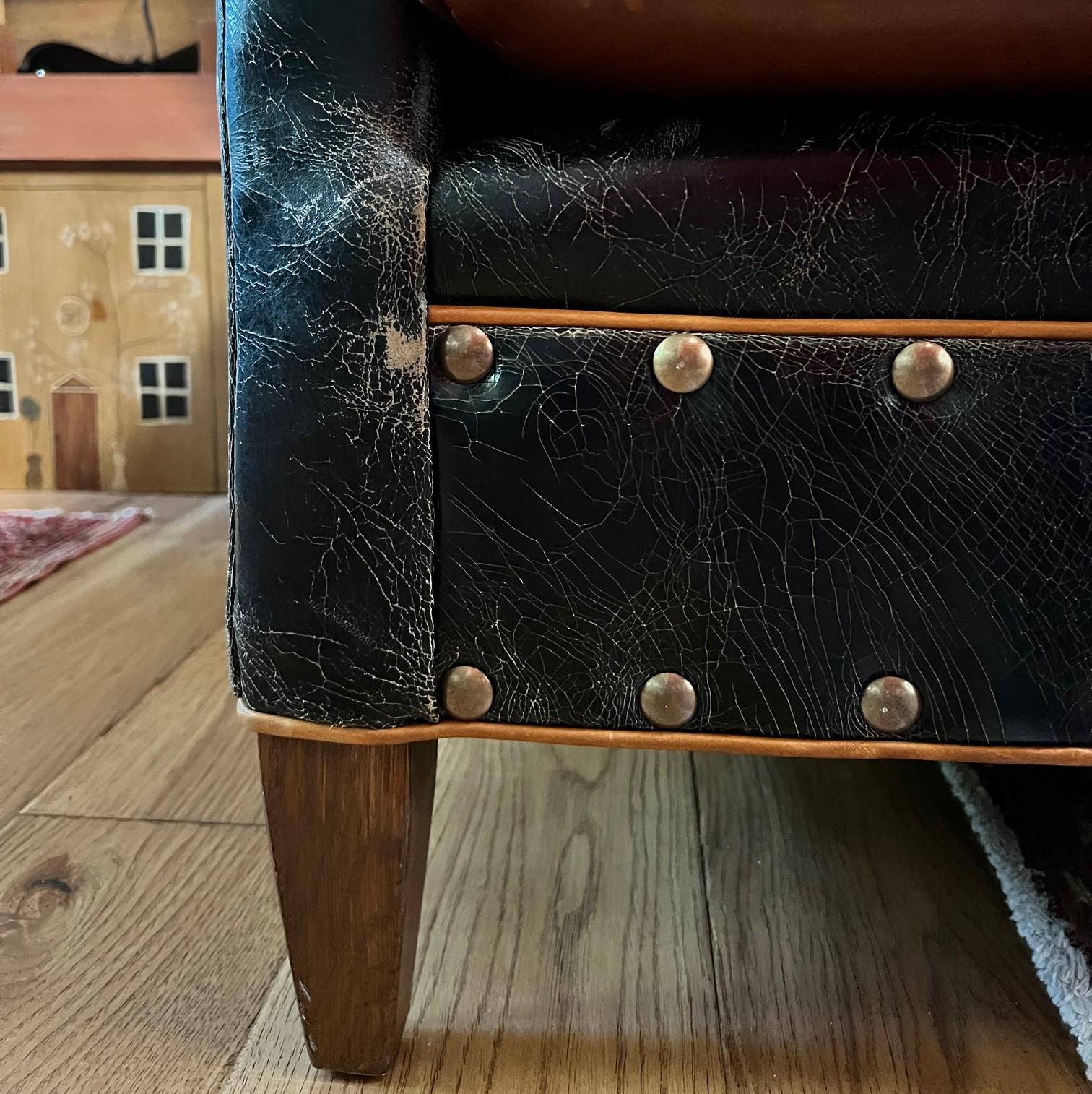 Vintage Distressed Black Leather Sofa with Caramel Seat and Nail Head Trim In Good Condition In Morristown, NJ