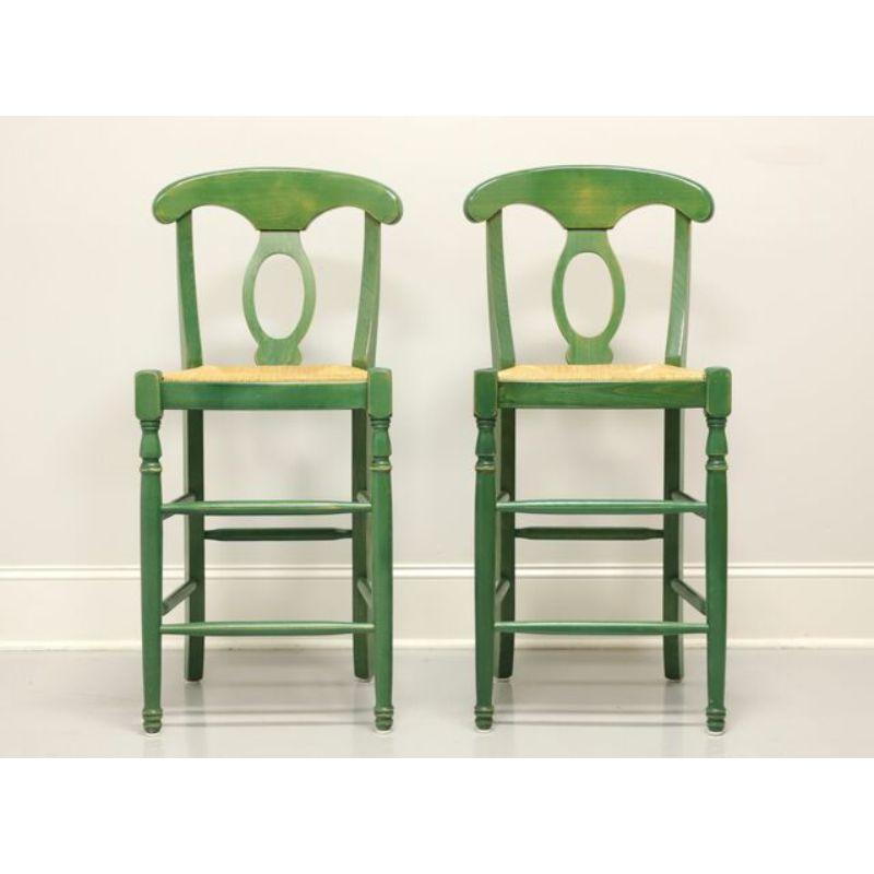 A pair of Cottage style barstools, unbranded. Solid wood with distressed green painted finish and rush seats. Features carved crest rail & backs, turned front legs and stretchers. Likely made in the USA, in the late 20th Century.

Measures: 20 W 20