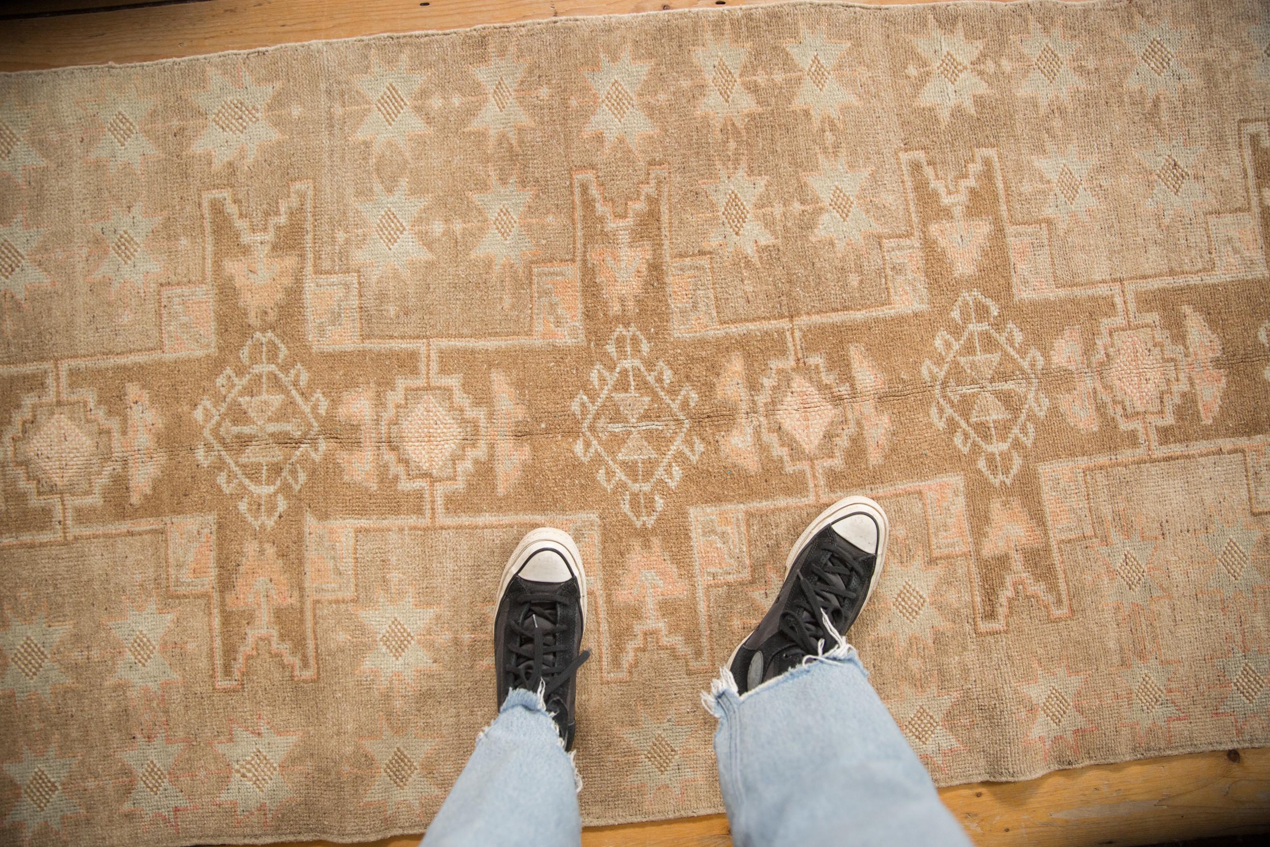 :: Repeating single column starburst geometric center medallions with interior hook and latch relief minor guls atop a covered abrashed field featuring starburst minor medallions. Regardless of being absent of a border, the rug appears to be in