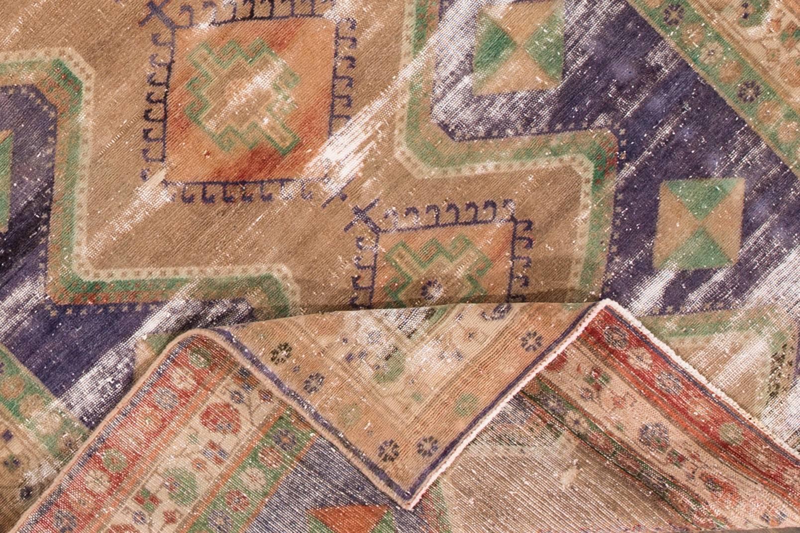 tapis Persan Tabriz vintage des années 1930. Cette pièce en mauvais état présente une large bordure claire et un motif géométrique multicolore au centre. Mesures : 4.11 x 9.02.