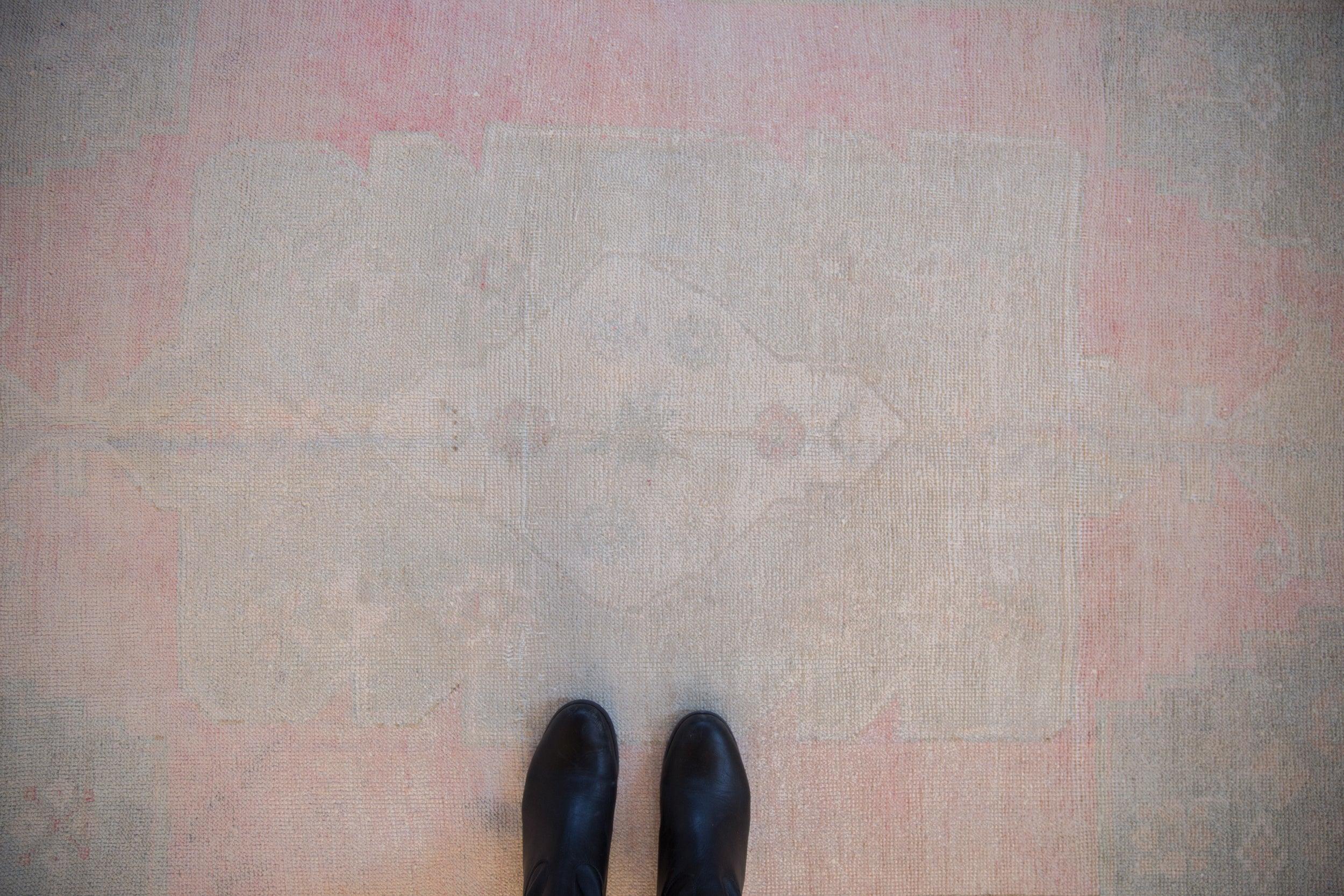 :: Oversized center medallion adorned by stepped finials atop an abrashed field. Colors and shades include: Pink, ivory, silver, platinum, pale dusty slate blue, and more. Condition notes: Even wear across to knot heads with faint foundation showing