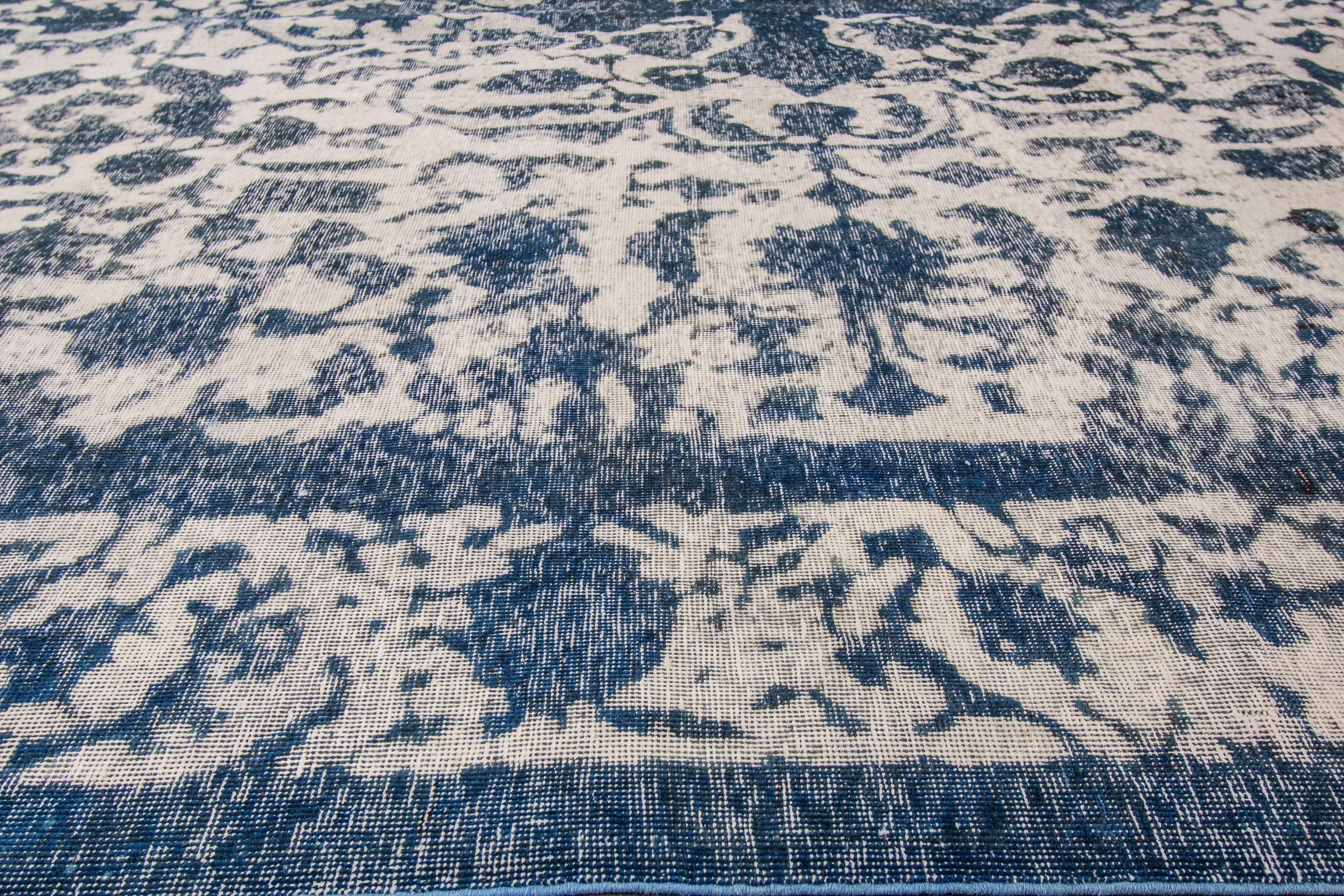 Vintage Persian hand-knotted overdyed rug with a medallion motif. This piece has great detailing and a beautiful design. Measures: 12'7