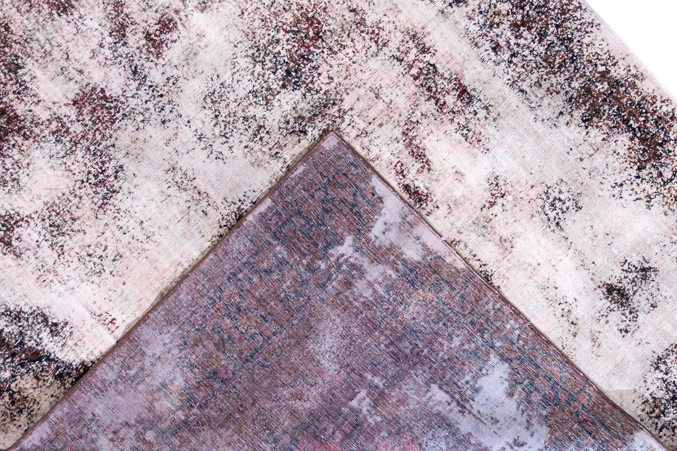 Vintage Persian hand knotted distressed and overdyed rug with a medallion design. This rug measures 8'1” x 11'9”.
 