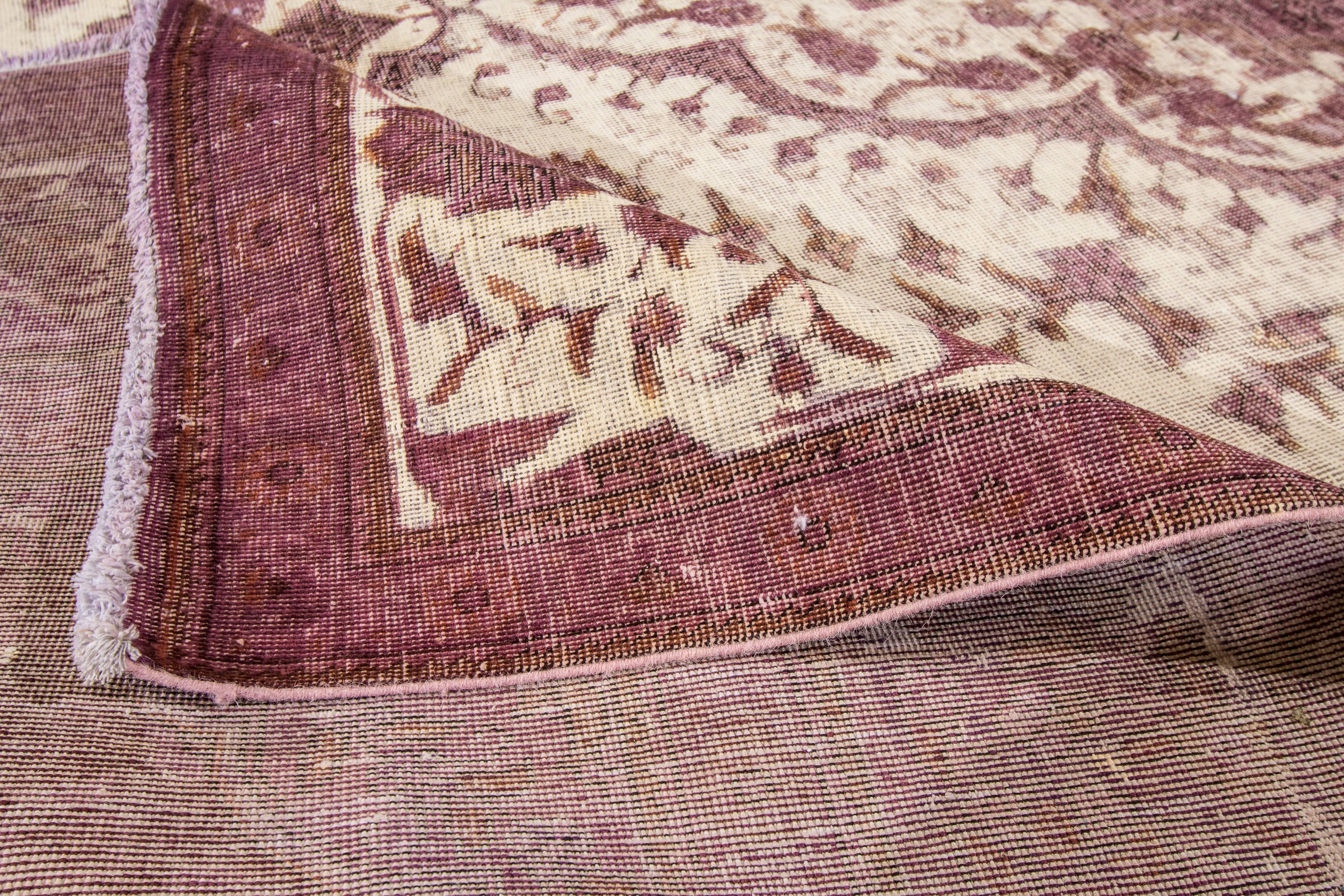 Vintage Persian hand-knotted overdyed rug with a medallion motif. This piece has great detailing and a beautiful design. Measures: 12'6