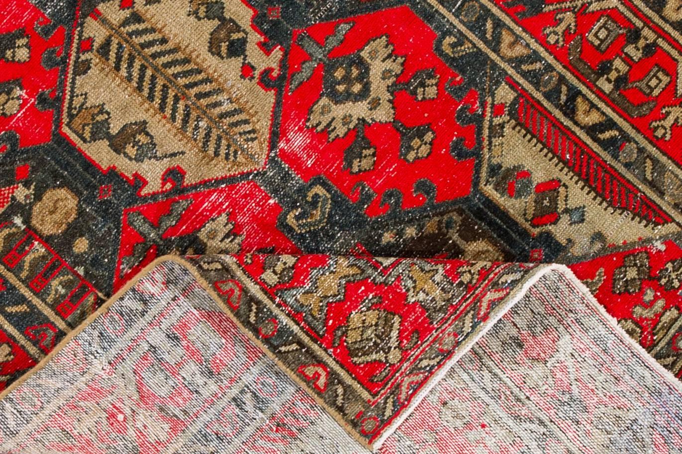 1930s vintage Persian Tabriz carpet. This distressed piece features a bright red field and geometric design in brown, accented with cream tones. Measures: 4 x 6.08.