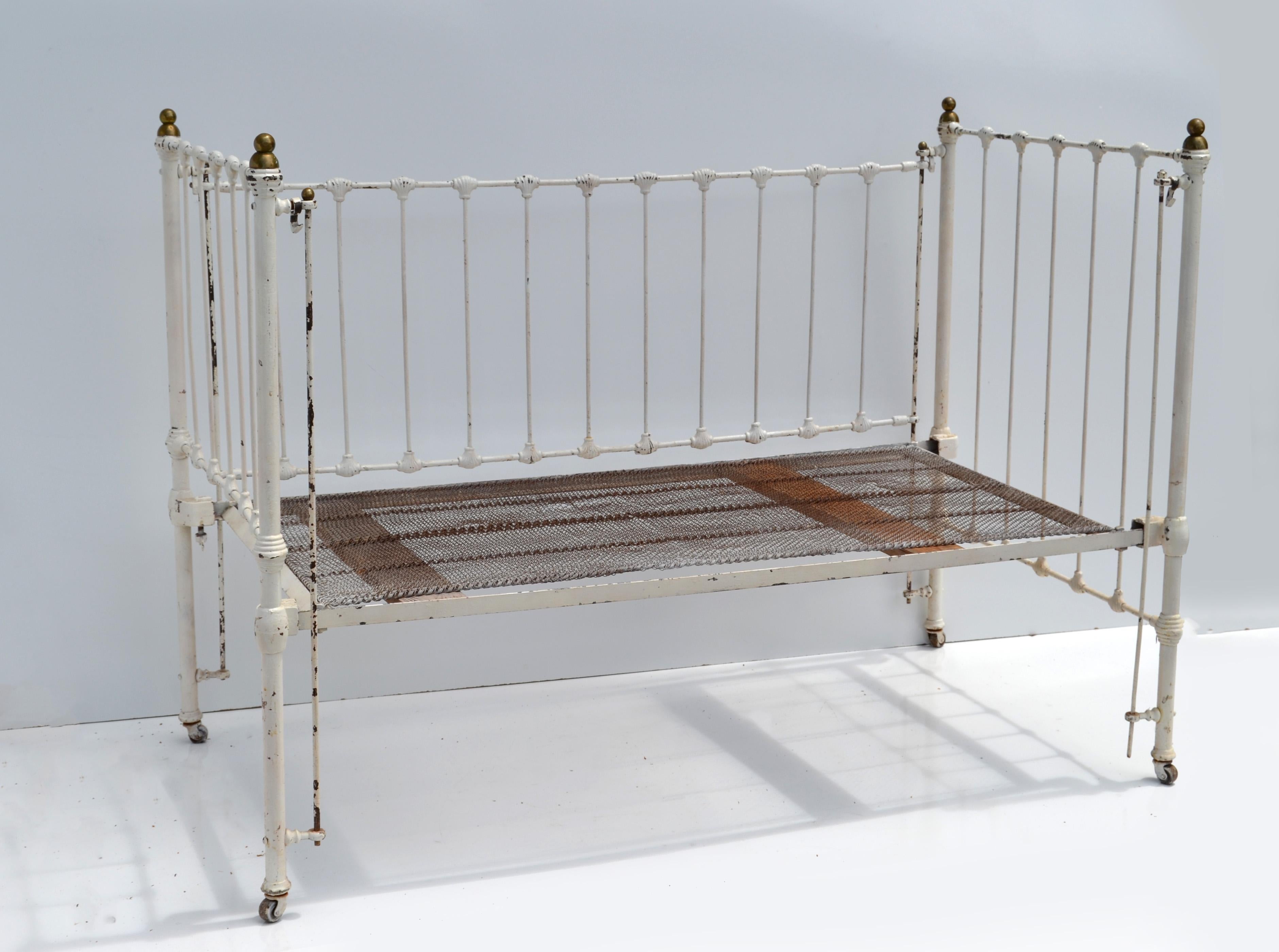 Beautiful Vintage antique distressed white finished Iron Crib with Nautical Shells and Brass knobs on the Top.
Comes with Springs on Slat Boards.
Rustic County Cottage Style with Shabby Chic Look.
Can be used with a Standard Size Crib Mattress (NOT