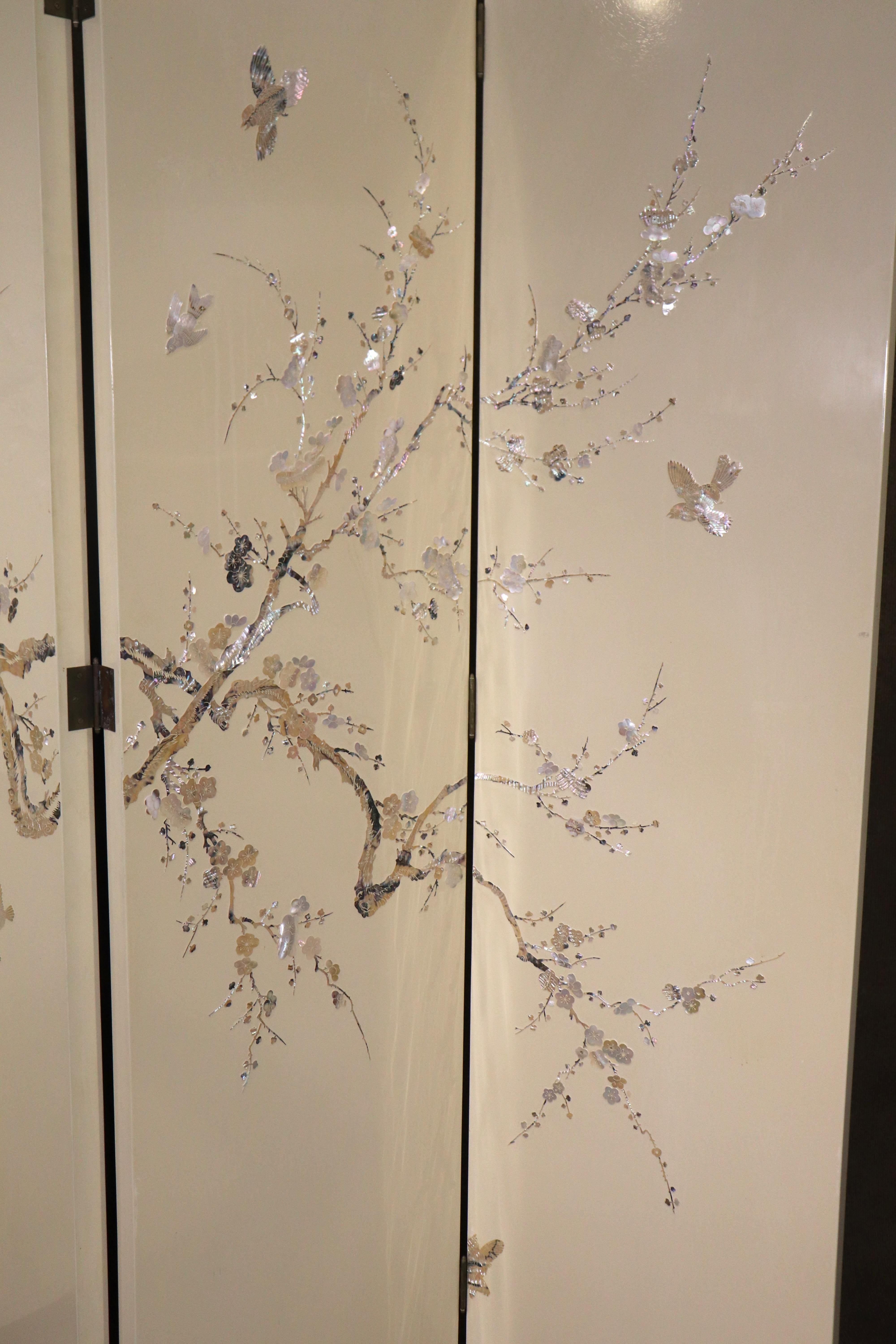 Gorgeous folding screen with mother of pearl designs. Asian style design with birds in trees, all done with iridescent pearl.
Each panel is 18