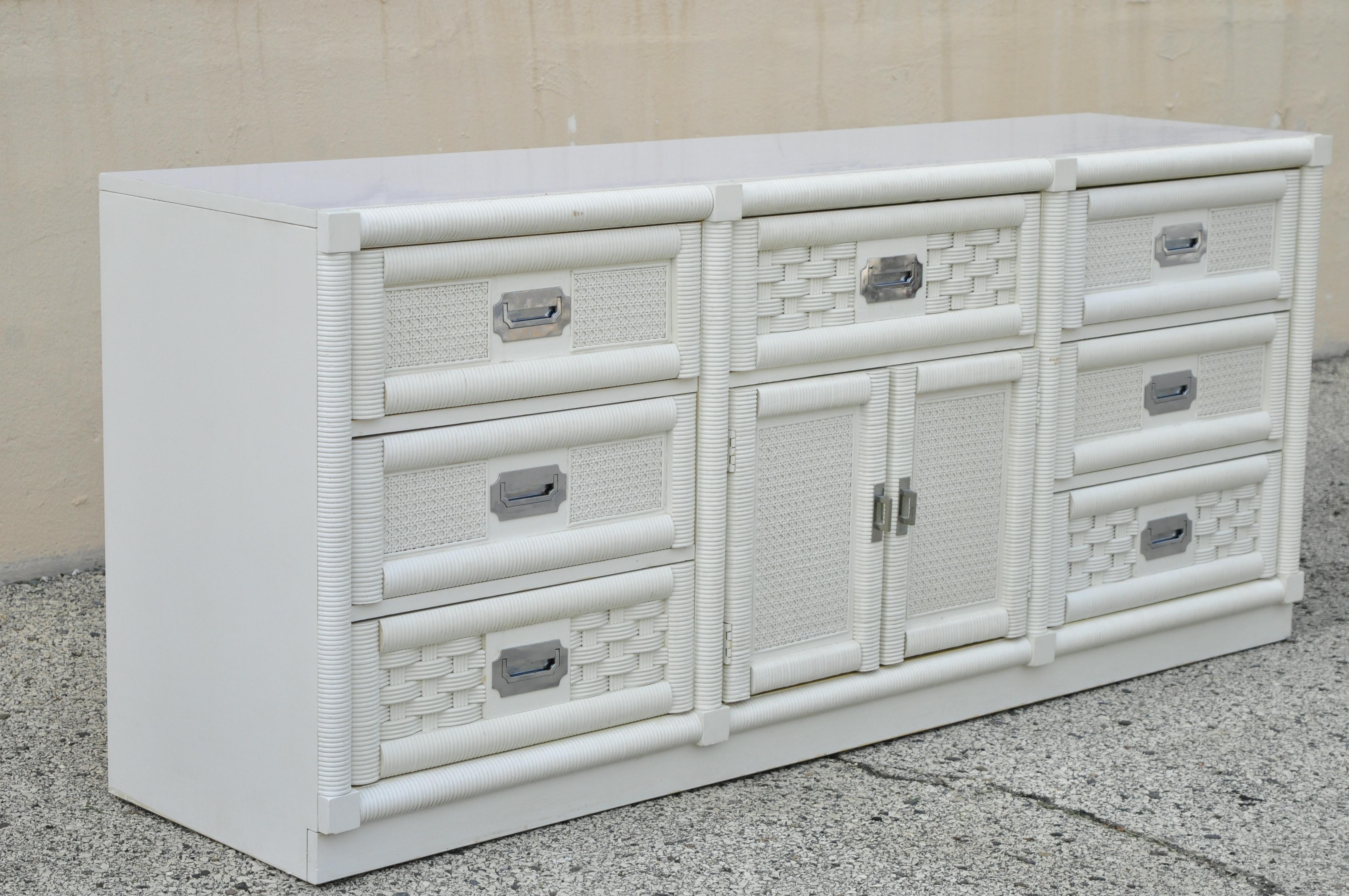 Vintage Dixie Cane rattan Campaign white long dresser credenza cabinet. Item features laminate top, chrome campaign style handles, rattan and cane front, 9 dovetailed drawers, white/cream lacquer finish, 2 swing doors, original stamp, quality